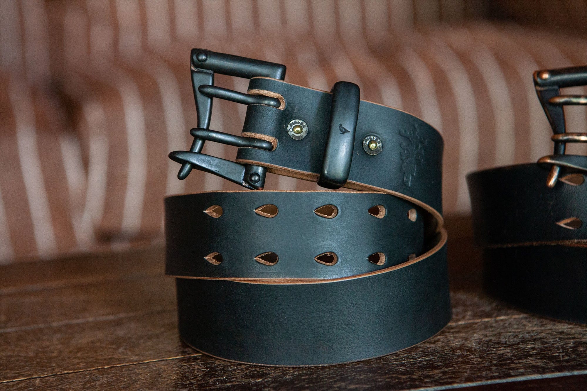 New Pigeon Tree Ultimate Teacore horsehide belt coiled with riveted buckle attachment.