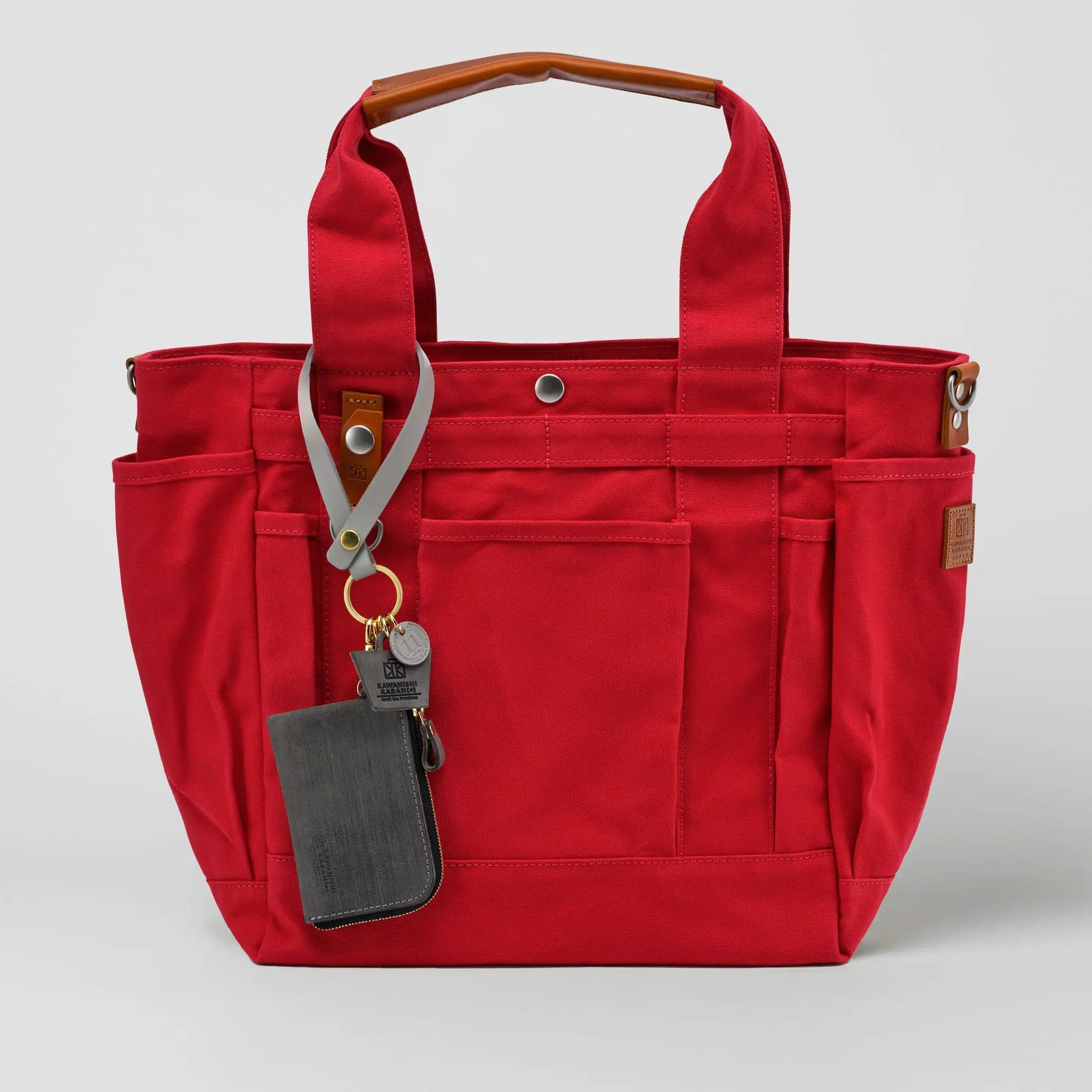 Red full-size anniversary grabe tote with grey wallet charm