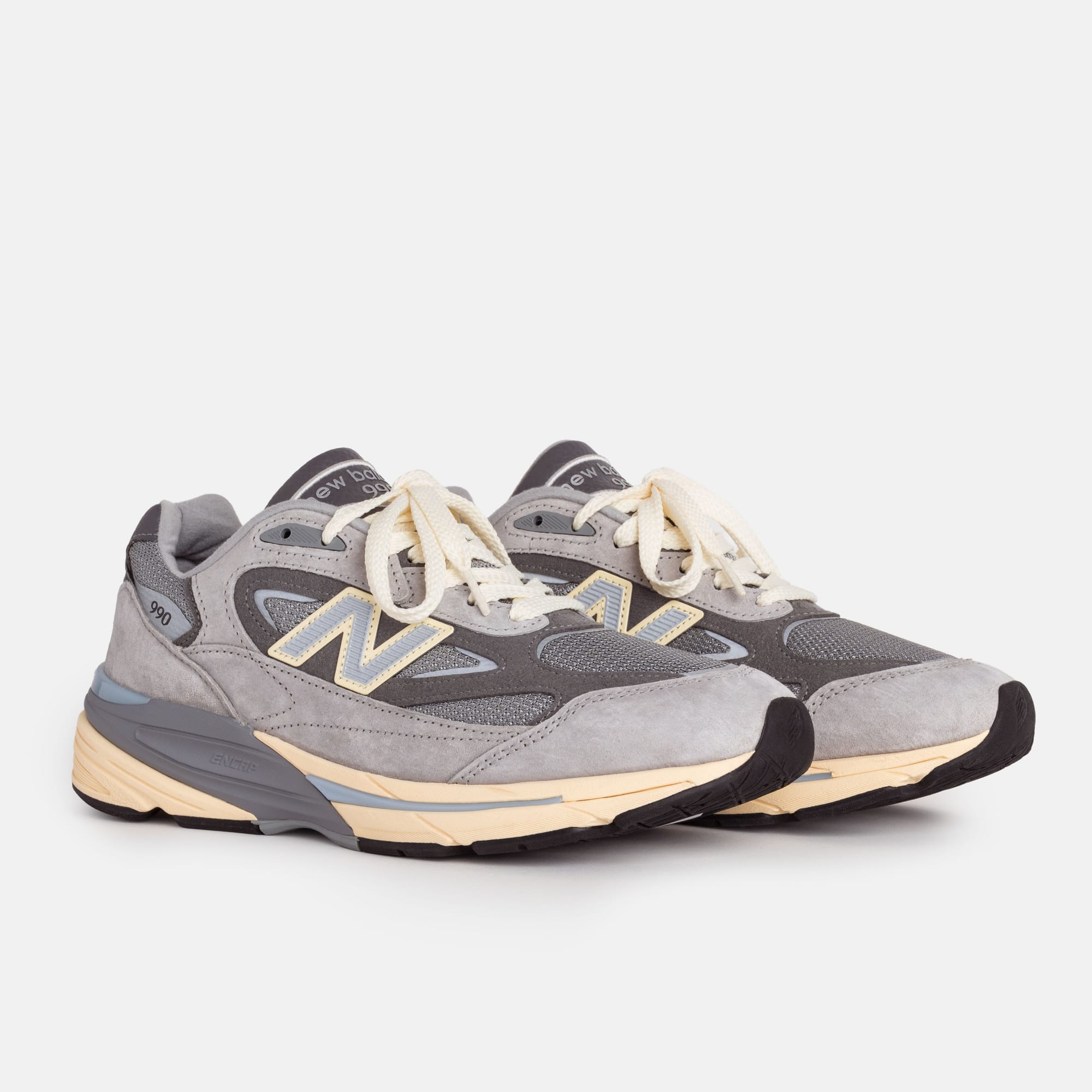 Grey New Balance U990GR7 pair, three-quarter studio view