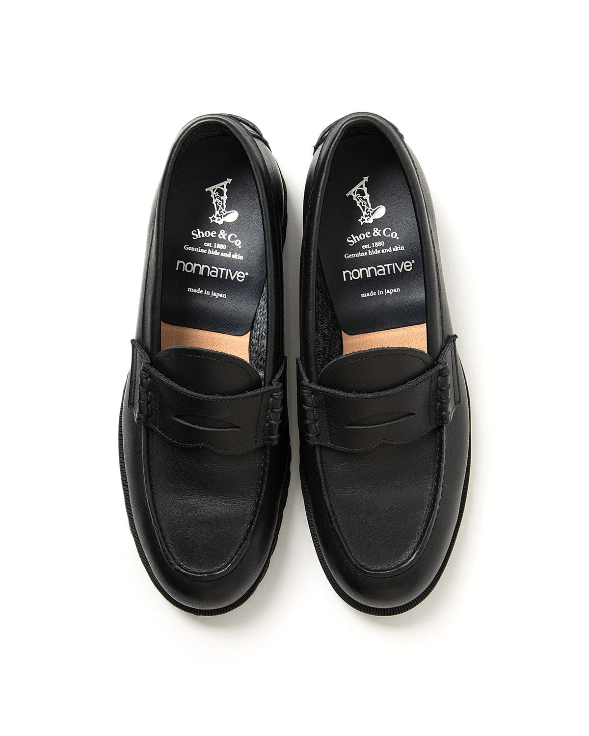Top view of the black loafer pair and branded insoles.