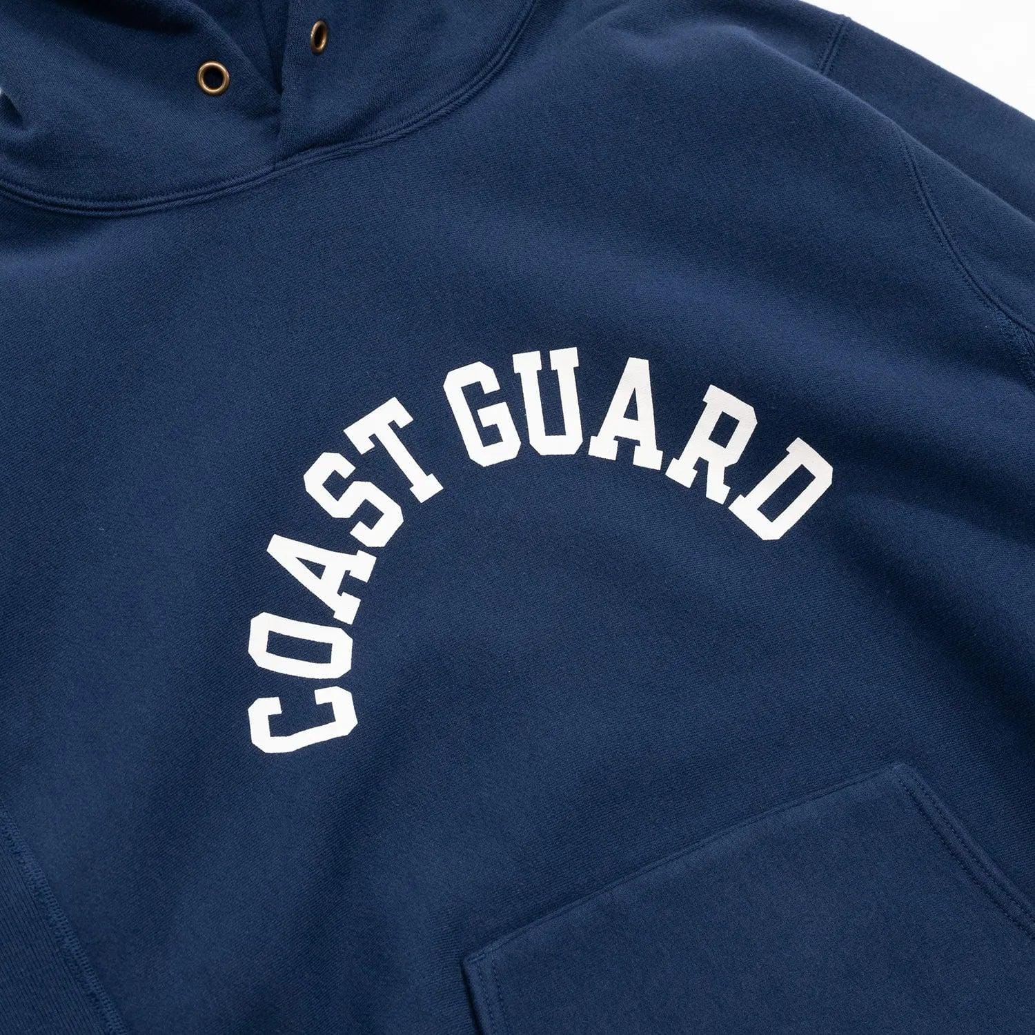COAST GUARD lettering printed across the navy hooded sweatshirt chest.