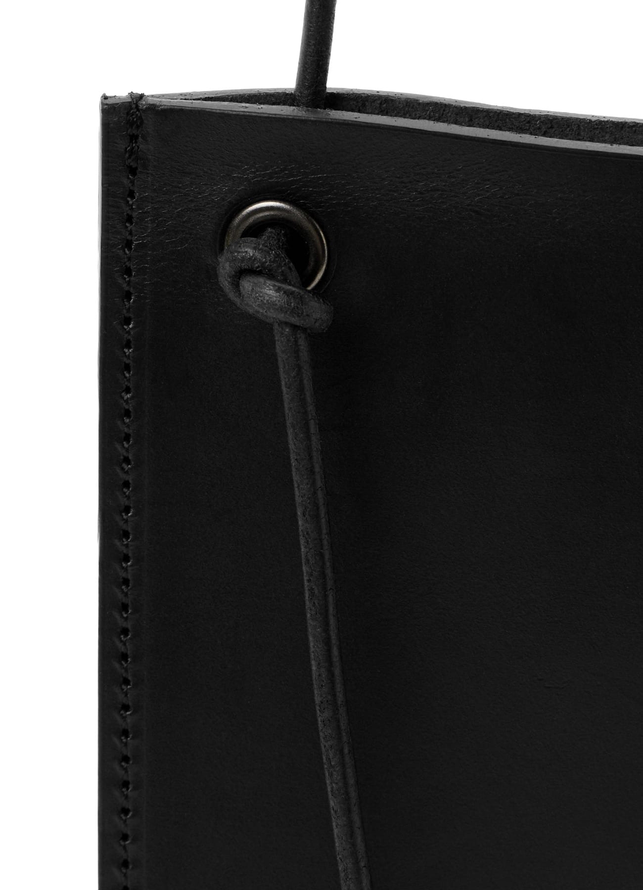 Shoulder bag strap attachment and leather surface detail
