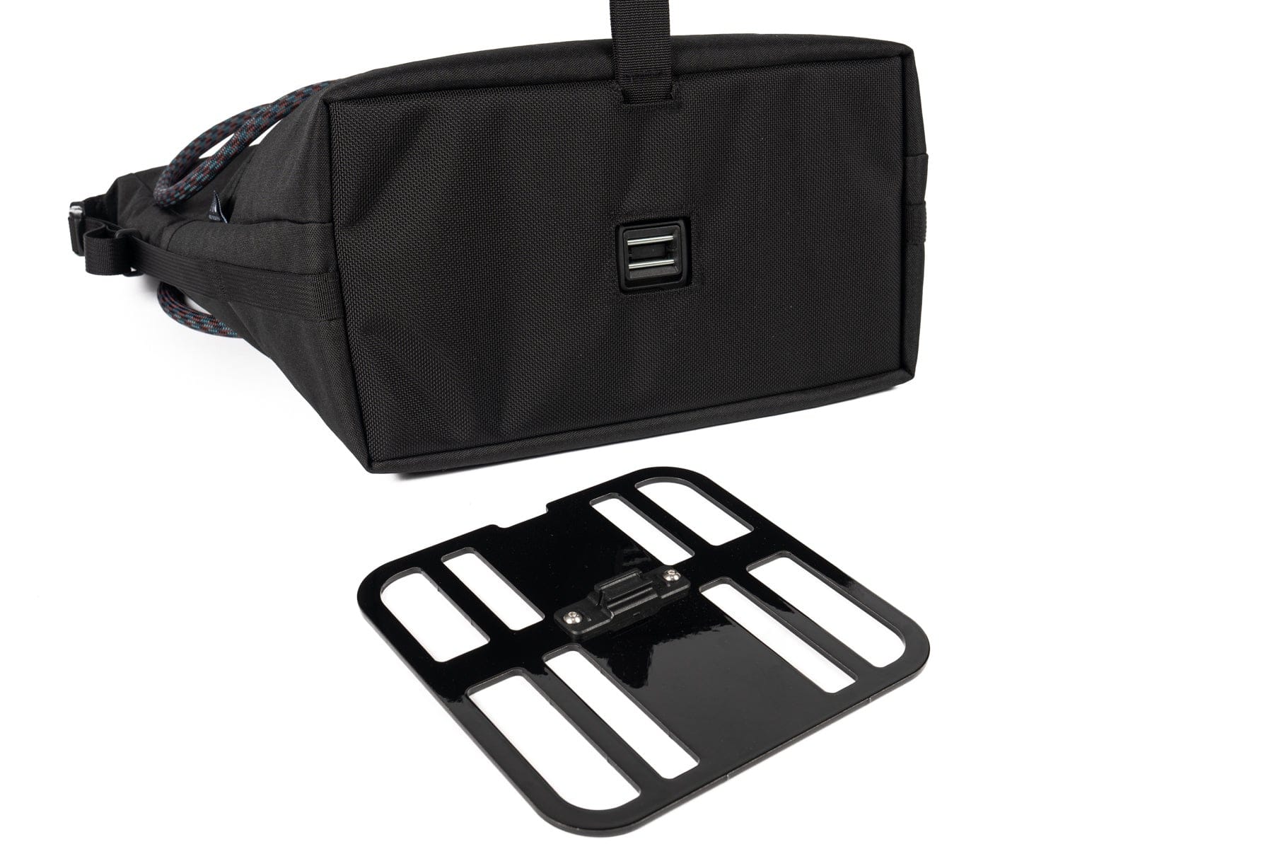 Underside of the Outer Shell QR Tote beside its separate magnetic mounting plate.