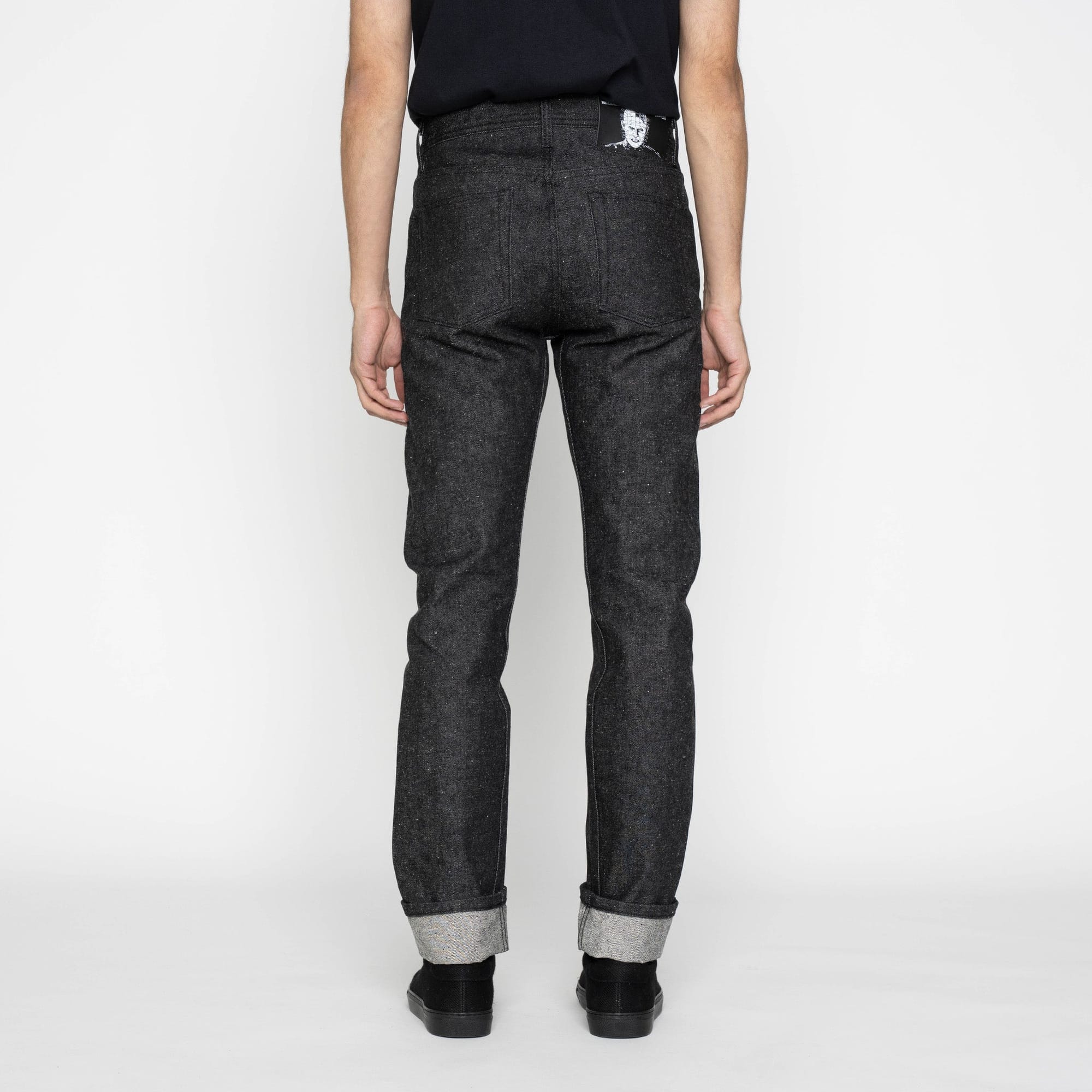 Rear view showing the jeans’ pockets and Pinhead patch.