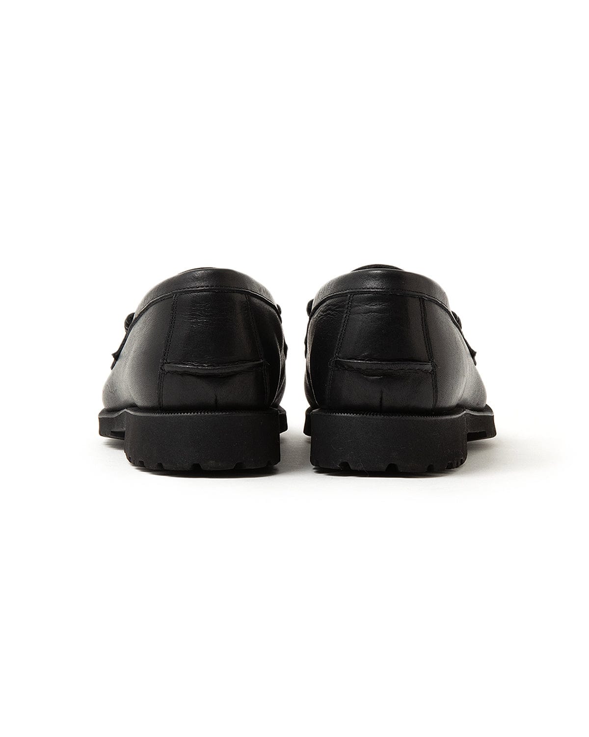 Rear view of the loafer pair and raised rubber heels.