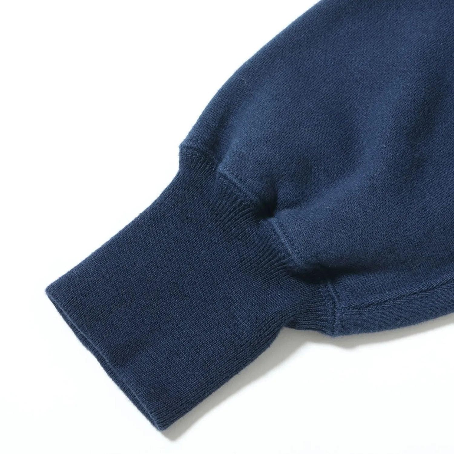 Ribbed sleeve cuff and seam of the navy horizontal-knit sweat parka.