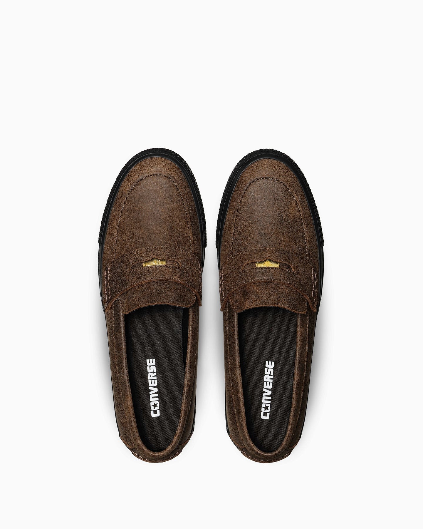Overhead view of the dark-brown loafers and their insoles.