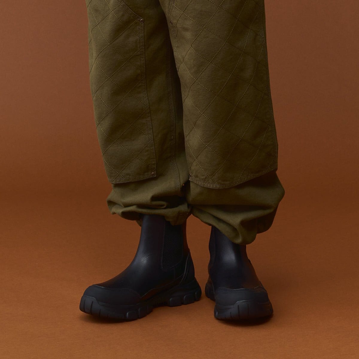 Close view of boots worn with olive trousers