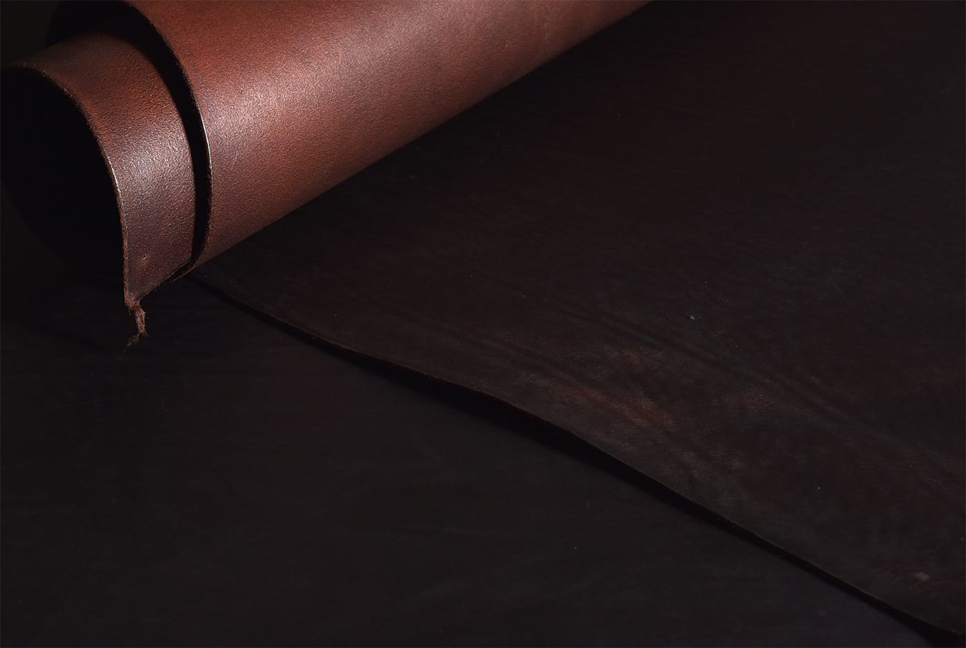 Dark leather trim shown in the HERZ suede collection material photographs.