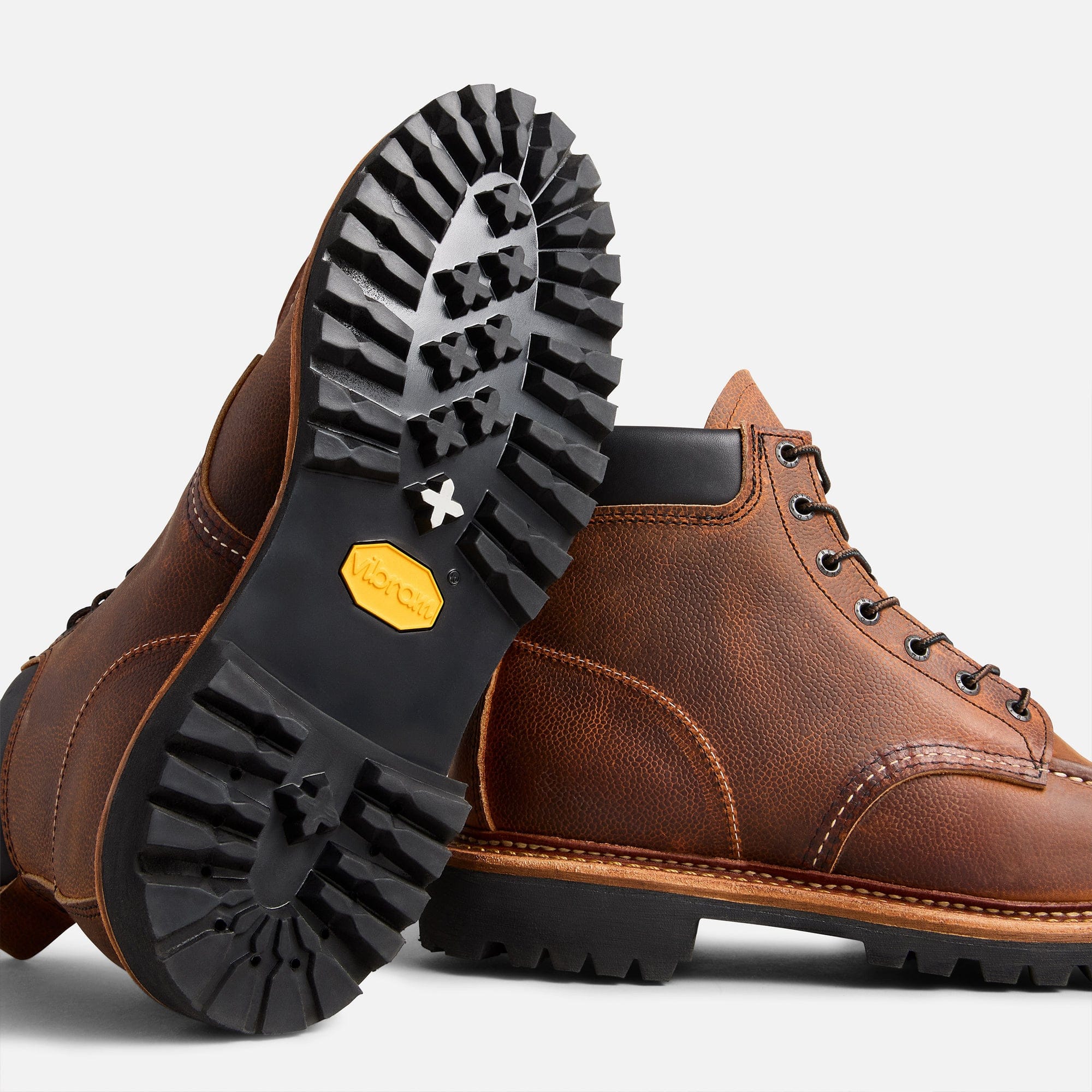 Red Wing 8213 boot beside its lug outsole.