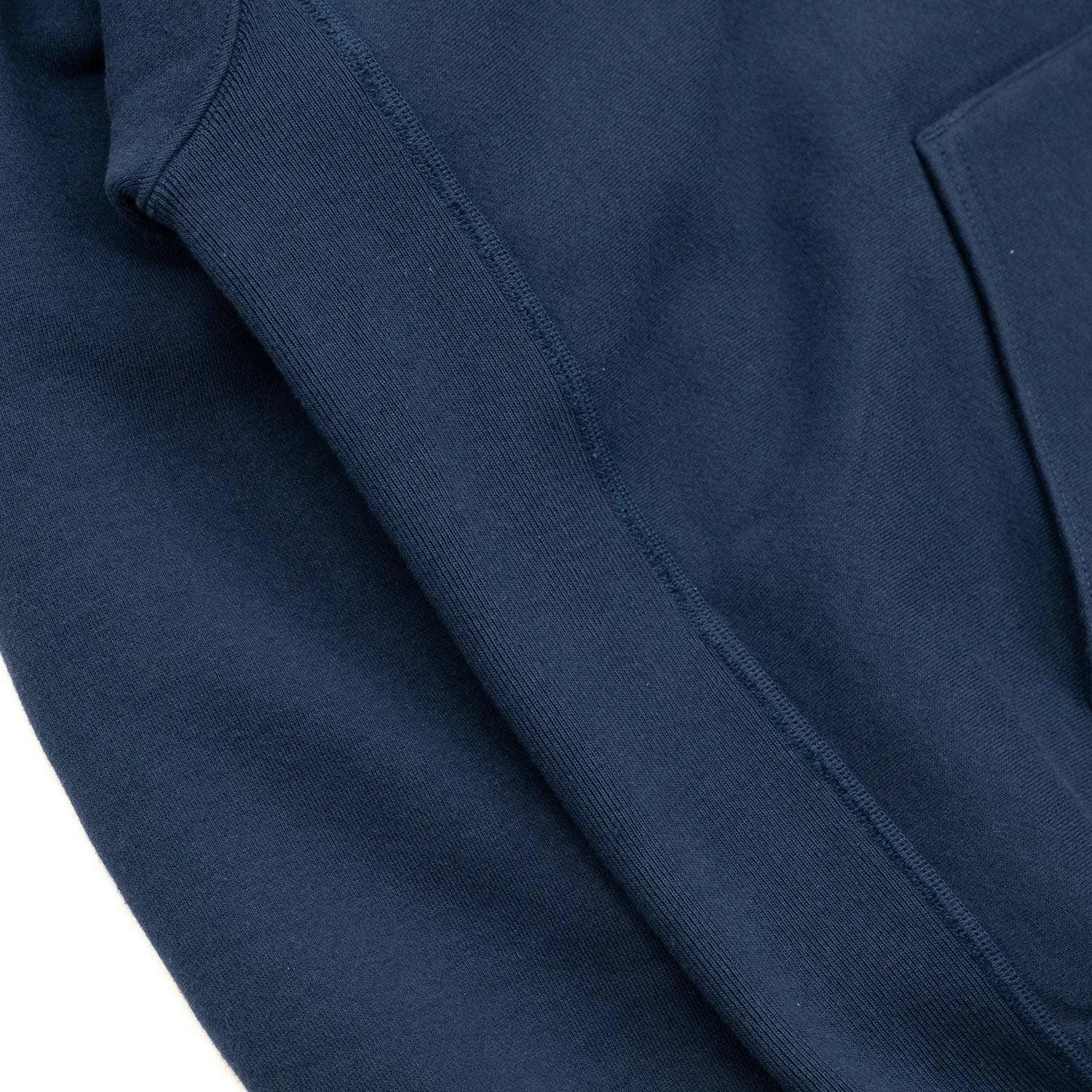 Close photograph of sewn panel and hoodie side seam.