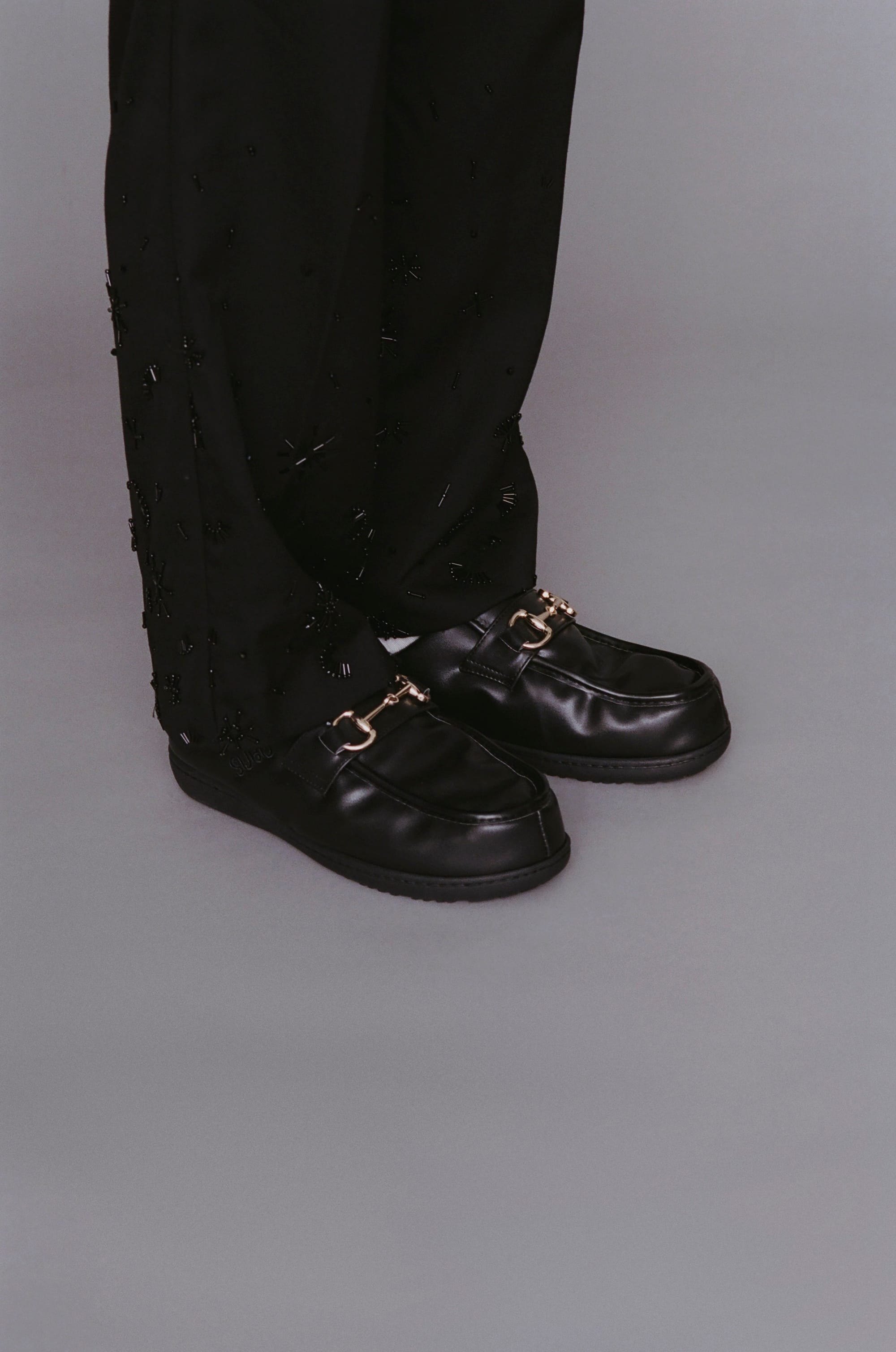 Model wearing DOTS LOAFER Black in the official anniversary collection lookbook