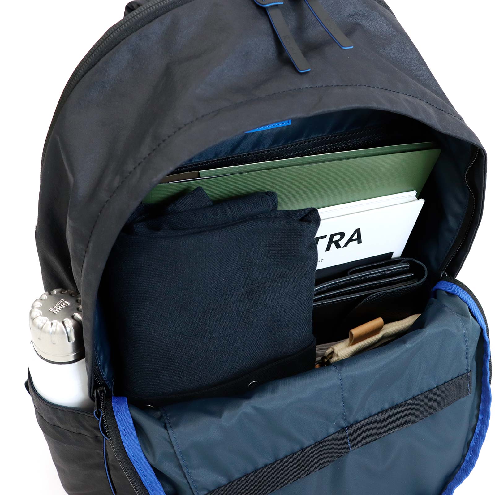 Open Float Daypack main compartment with example contents