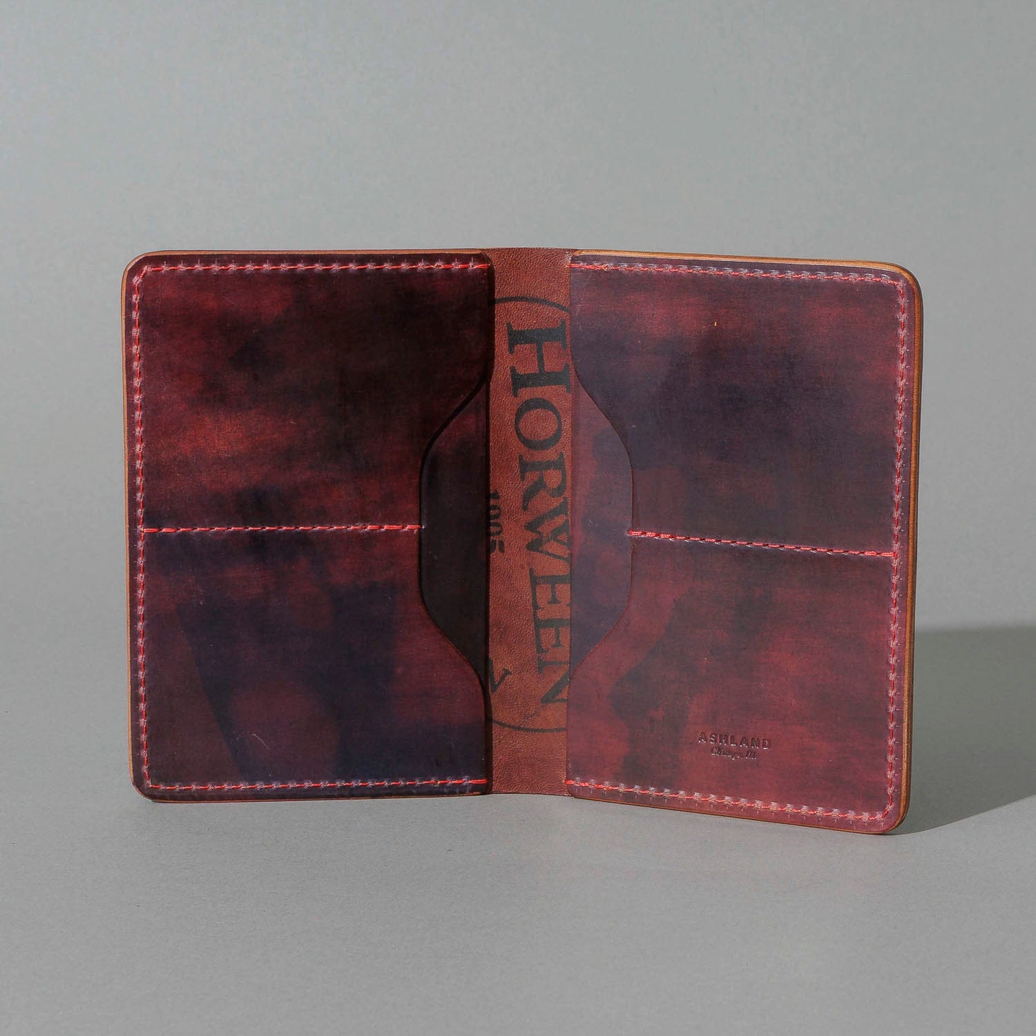 Open burgundy-finish leather wallet from the fall-release preview