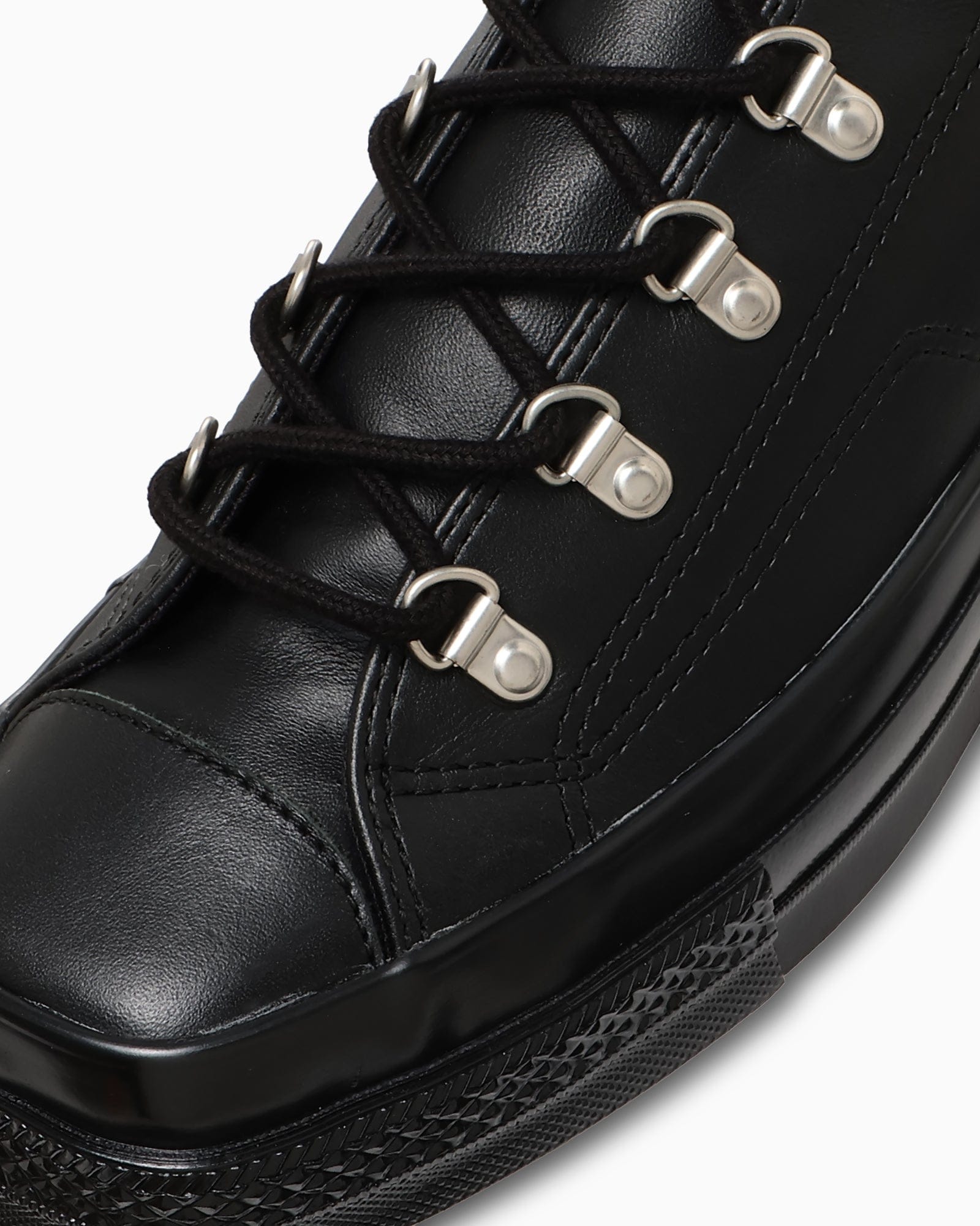 Close view of the metal D-rings and black laces.