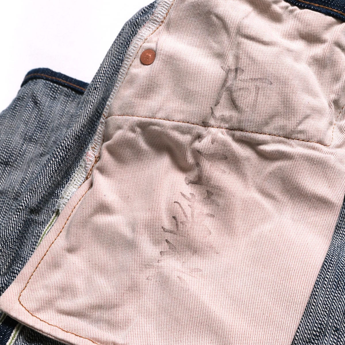 Pink-striped pocket bag beside the reverse of the denim.
