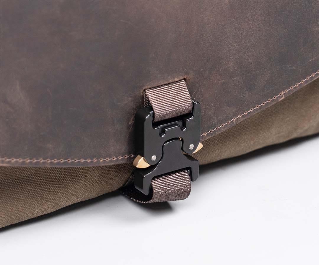 Close view of the Cargo flap buckle and leather edge.