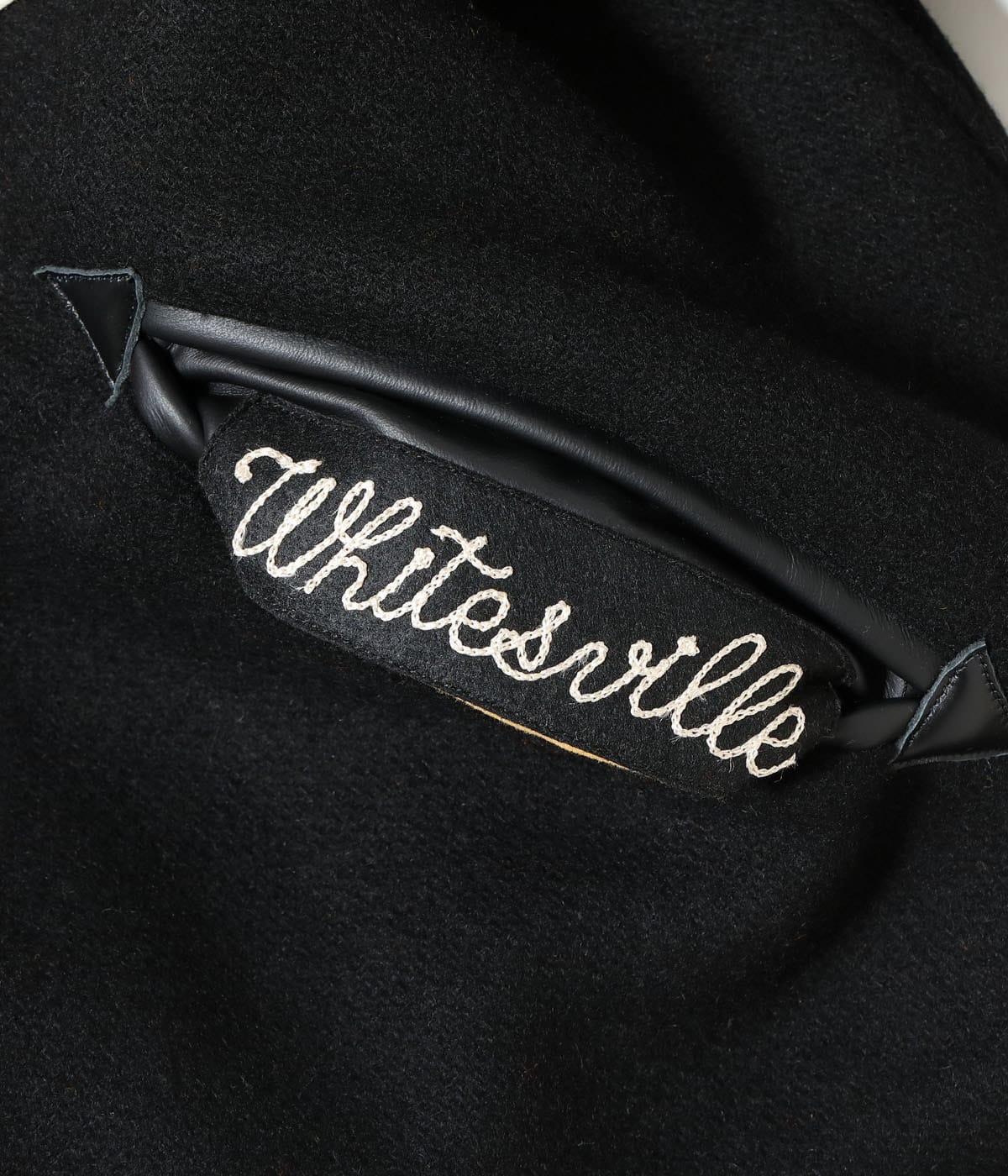 Leather-trimmed pocket detail