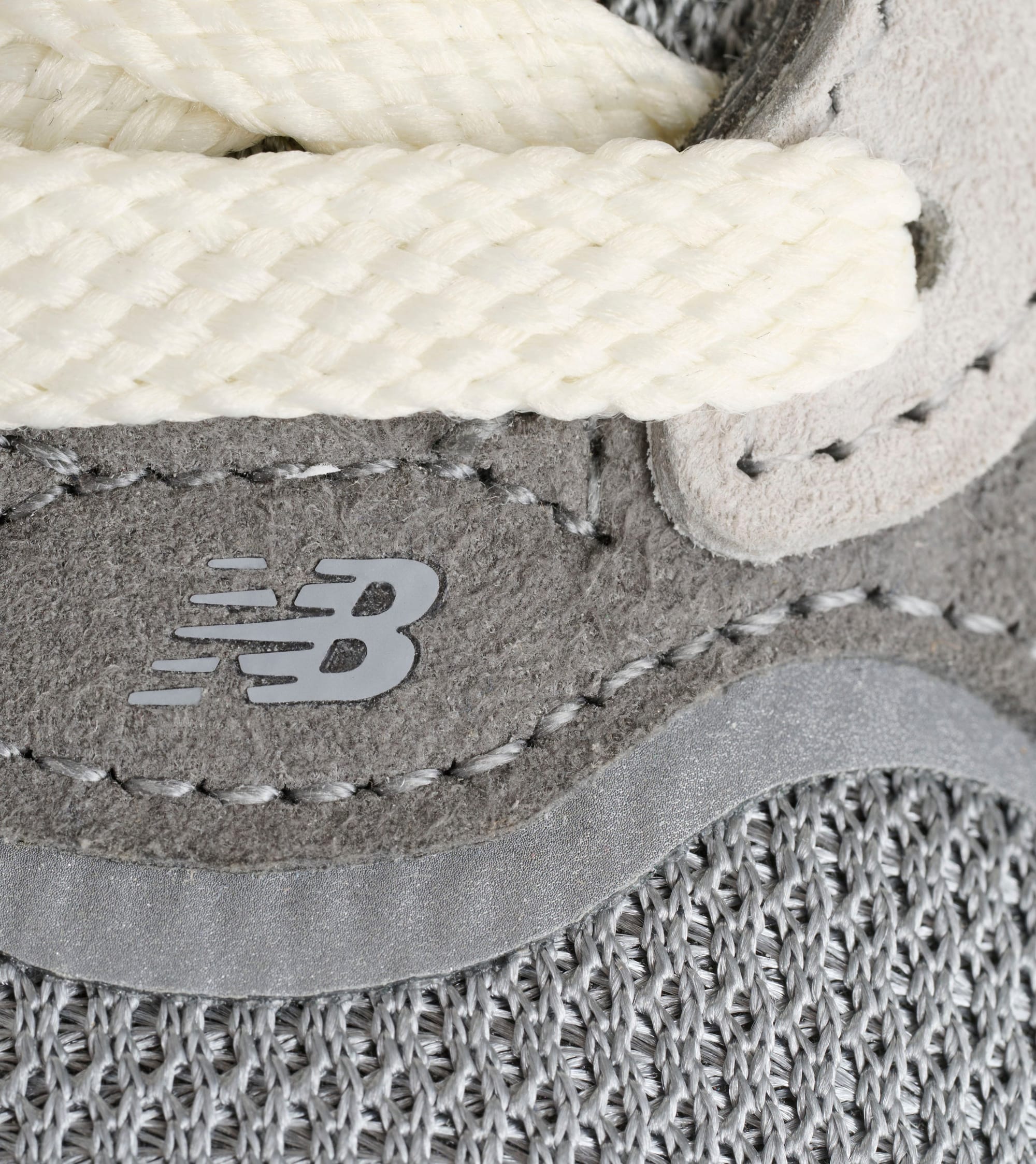 New Balance logo and suede stitching close-up on U990GR7