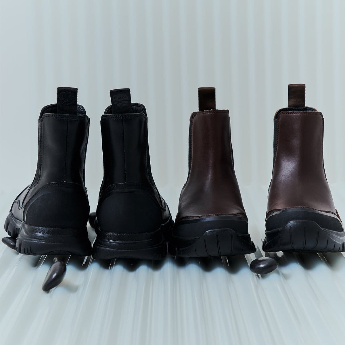Black and dark-brown TREK CHELSEA boots from the rear