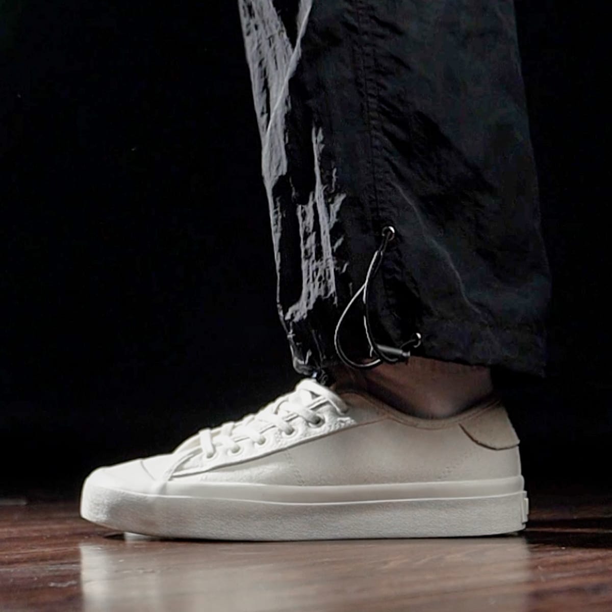 Natural White VTG V.2 low shoe worn with dark trousers