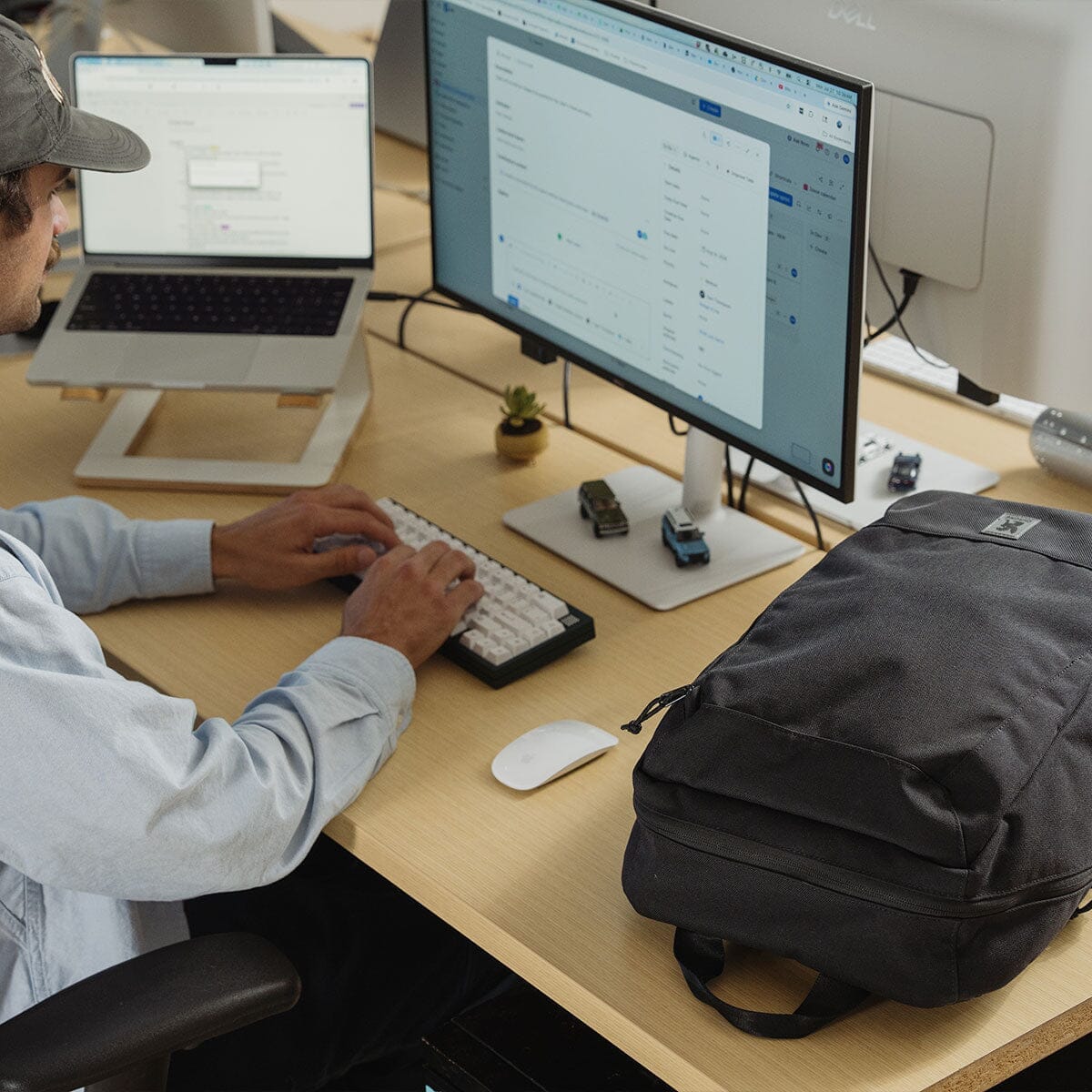 The Recruit bag beside a laptop workstation.