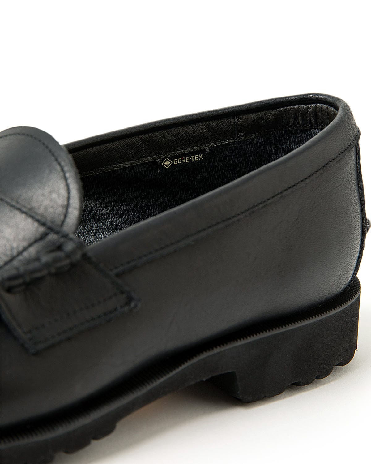 Close view of the black leather heel quarter and sole edge.