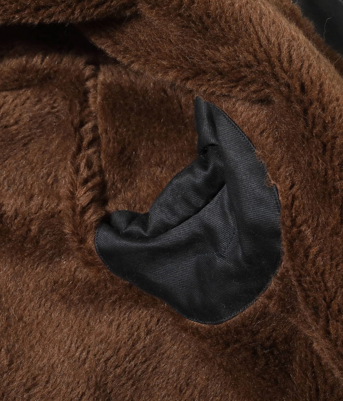Close detail of the dark pile lining and pocket panel.