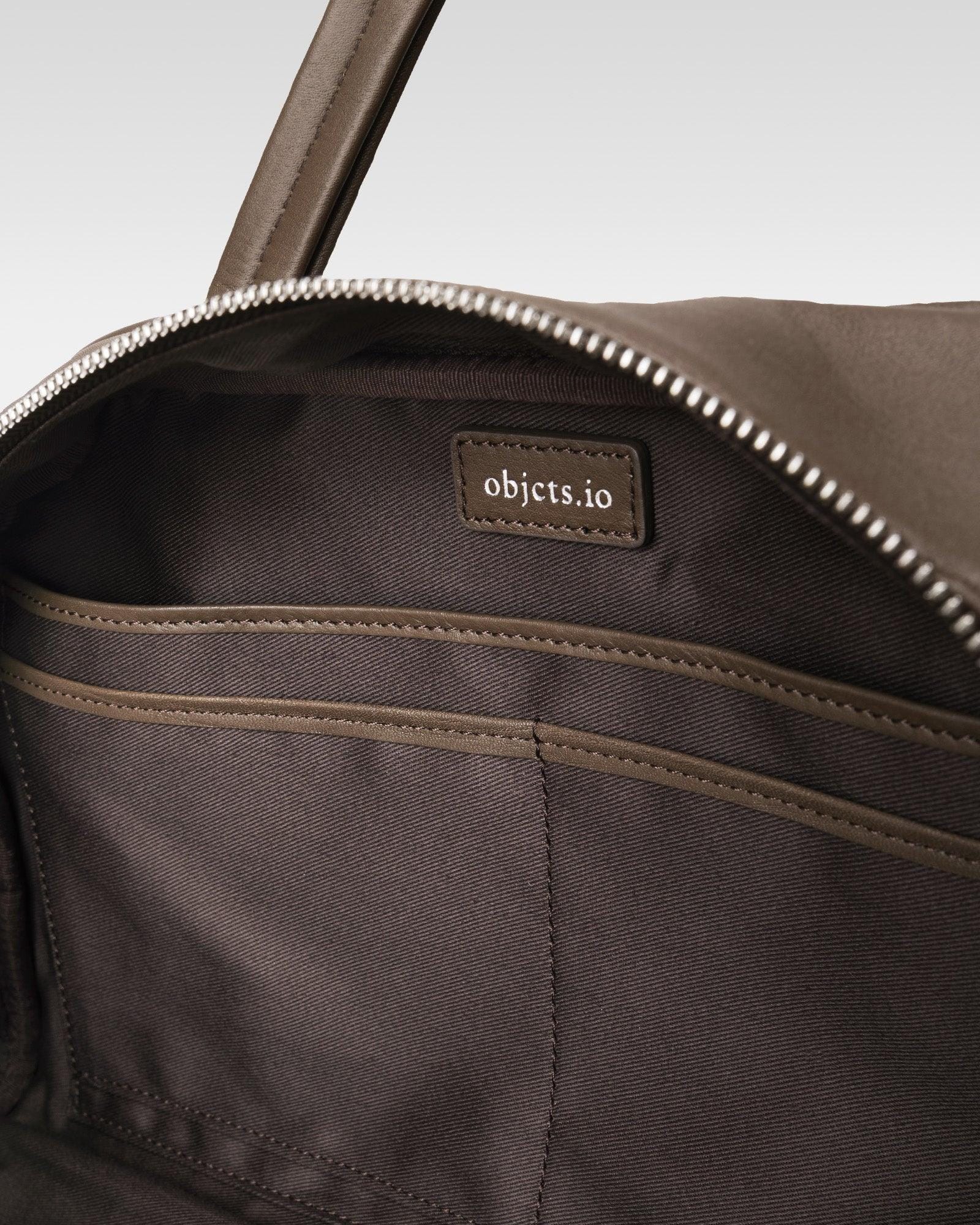 Close photograph of the lined Boston bag interior and inside organizer pockets.