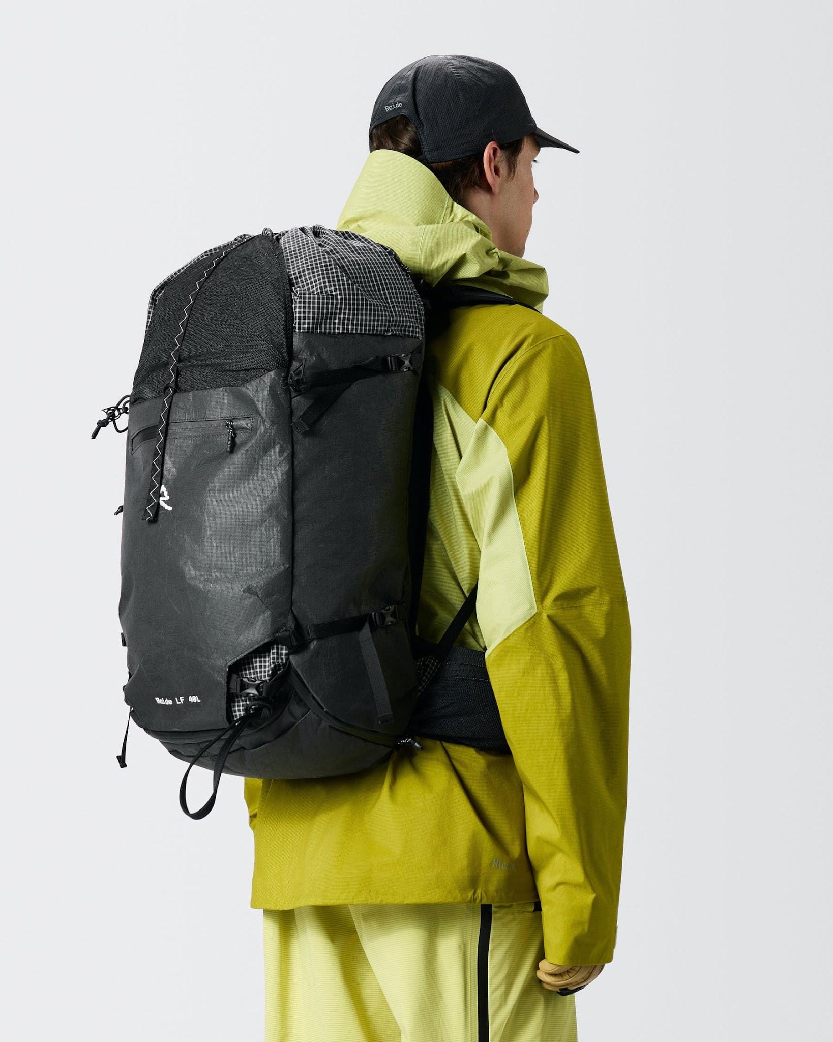 Raide LF40 in black shown in profile on a model in a green shell jacket.