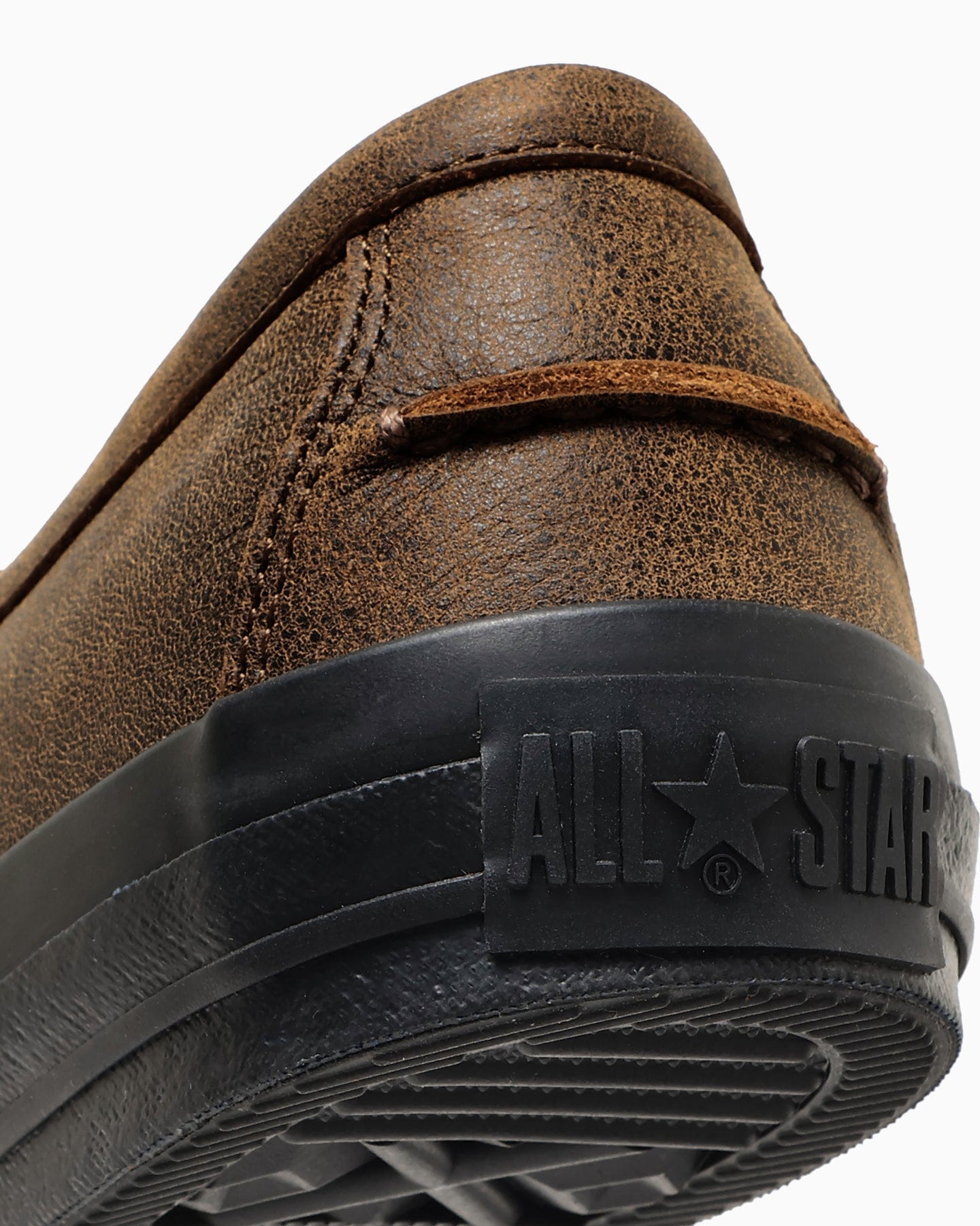 Close-up of the leather heel and black ALL STAR rubber branding.