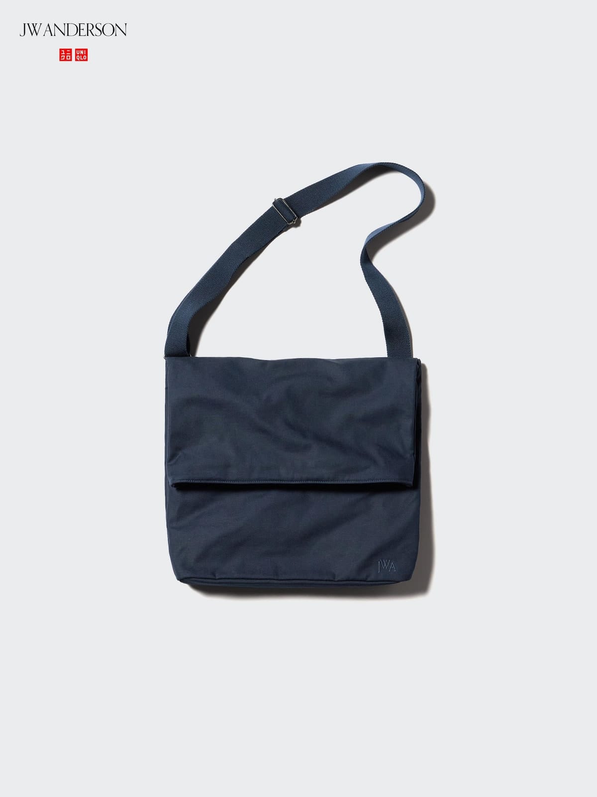 Navy UNIQLO and JW ANDERSON canvas shoulder bag with broad front flap