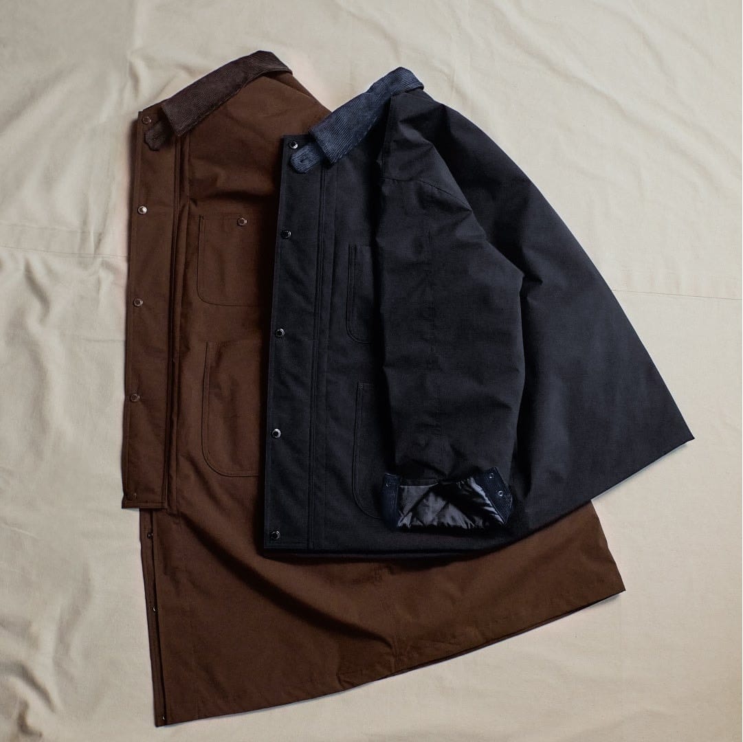 Brown long work coat and navy shortened work coat from GU and Engineered Garments.