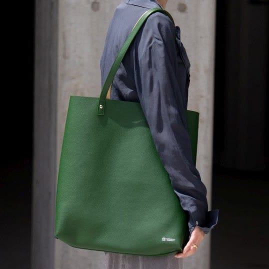 A green Kawanishi Dual Every tote carried over the shoulder.