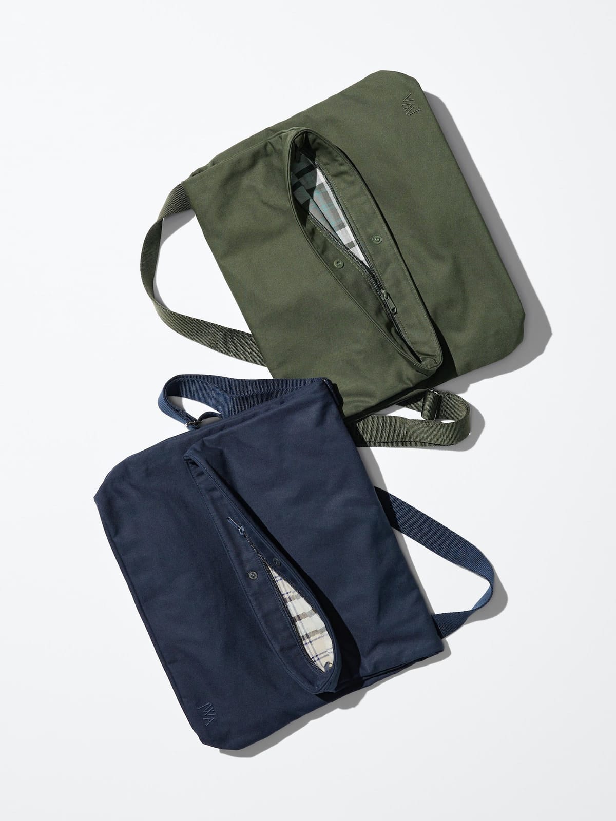 Olive and navy canvas bags laid flat with their check linings visible
