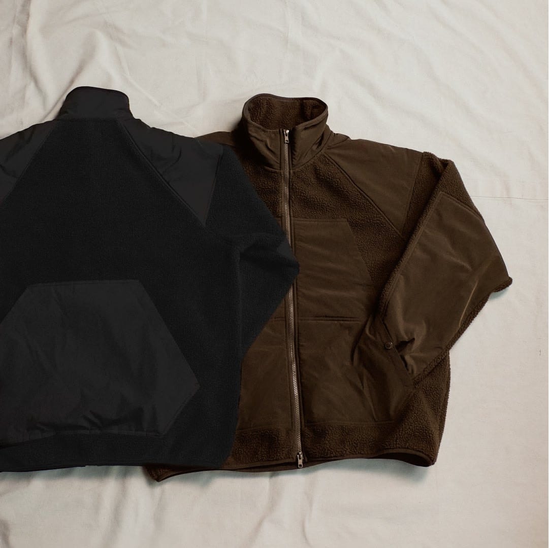 Brown and black fleece utility jackets with contrasting woven panels.
