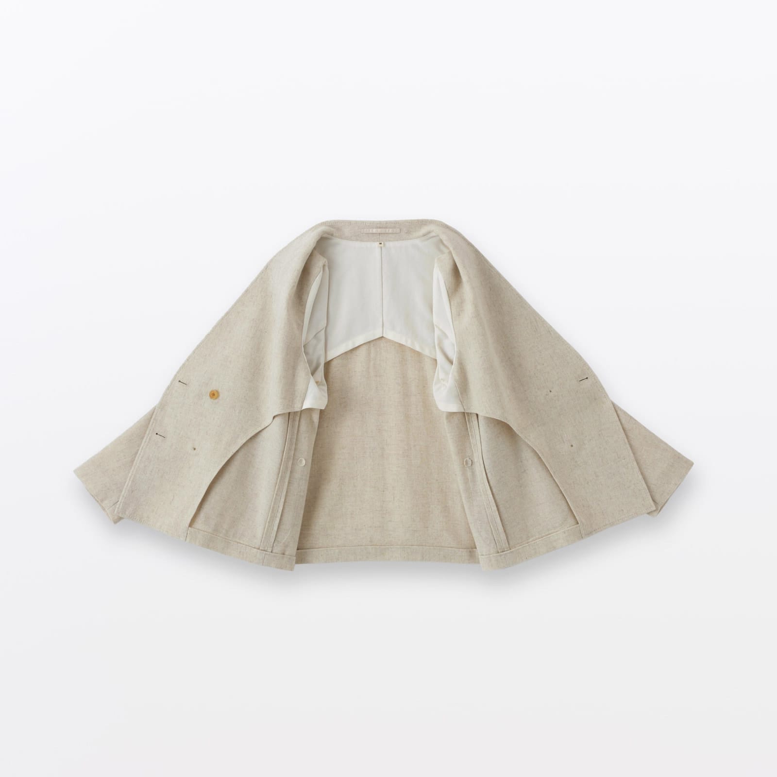 Ivory MUJI Labo jacket opened flat to reveal the inside construction