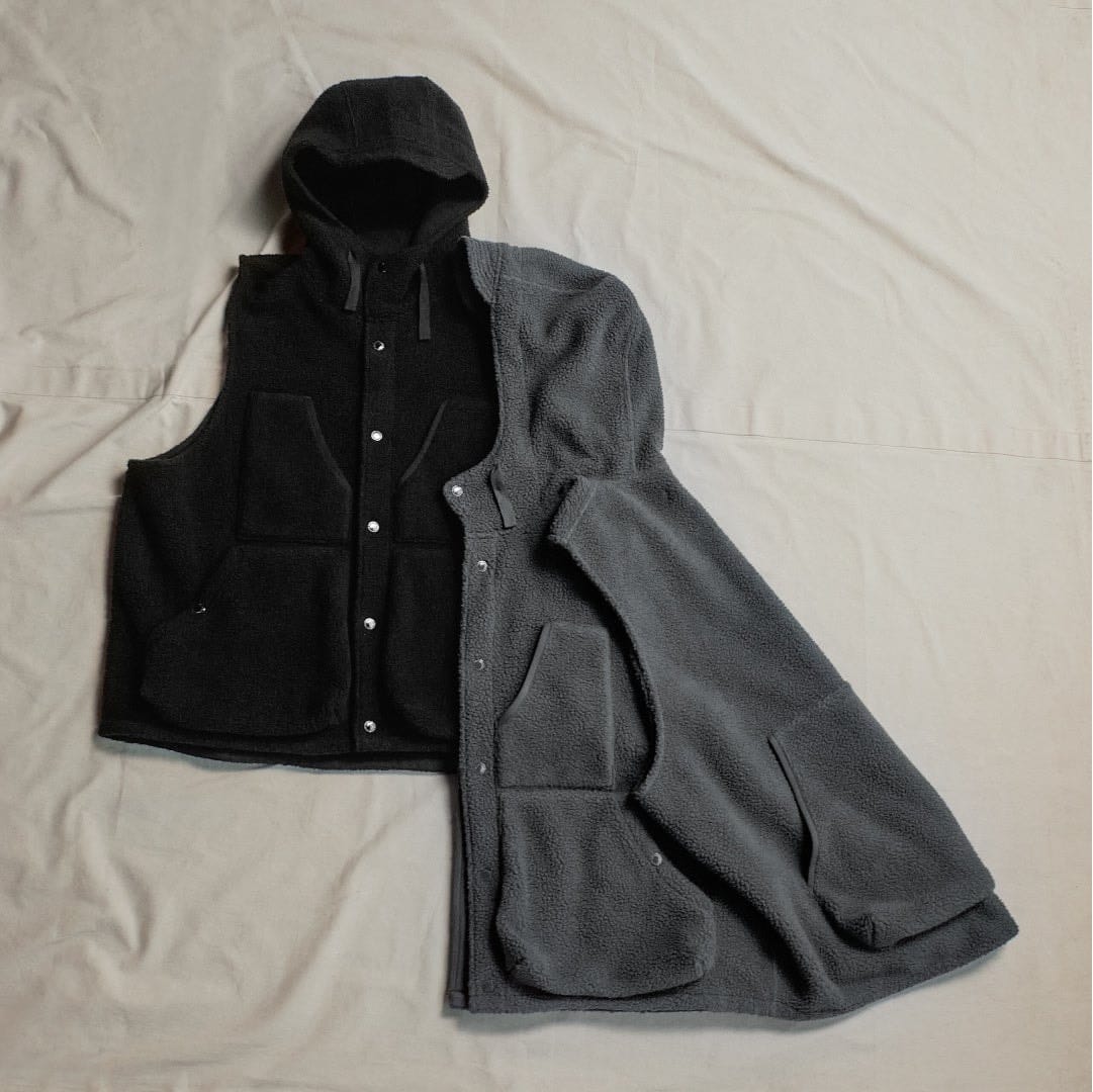 Grey and black hooded fleece vests from the GU and Engineered Garments collection.