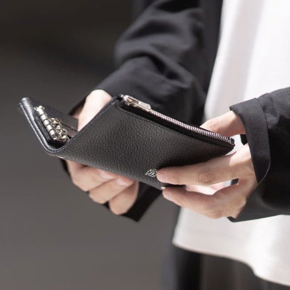 An open black Kawanishi Dual Book key case held in two hands.