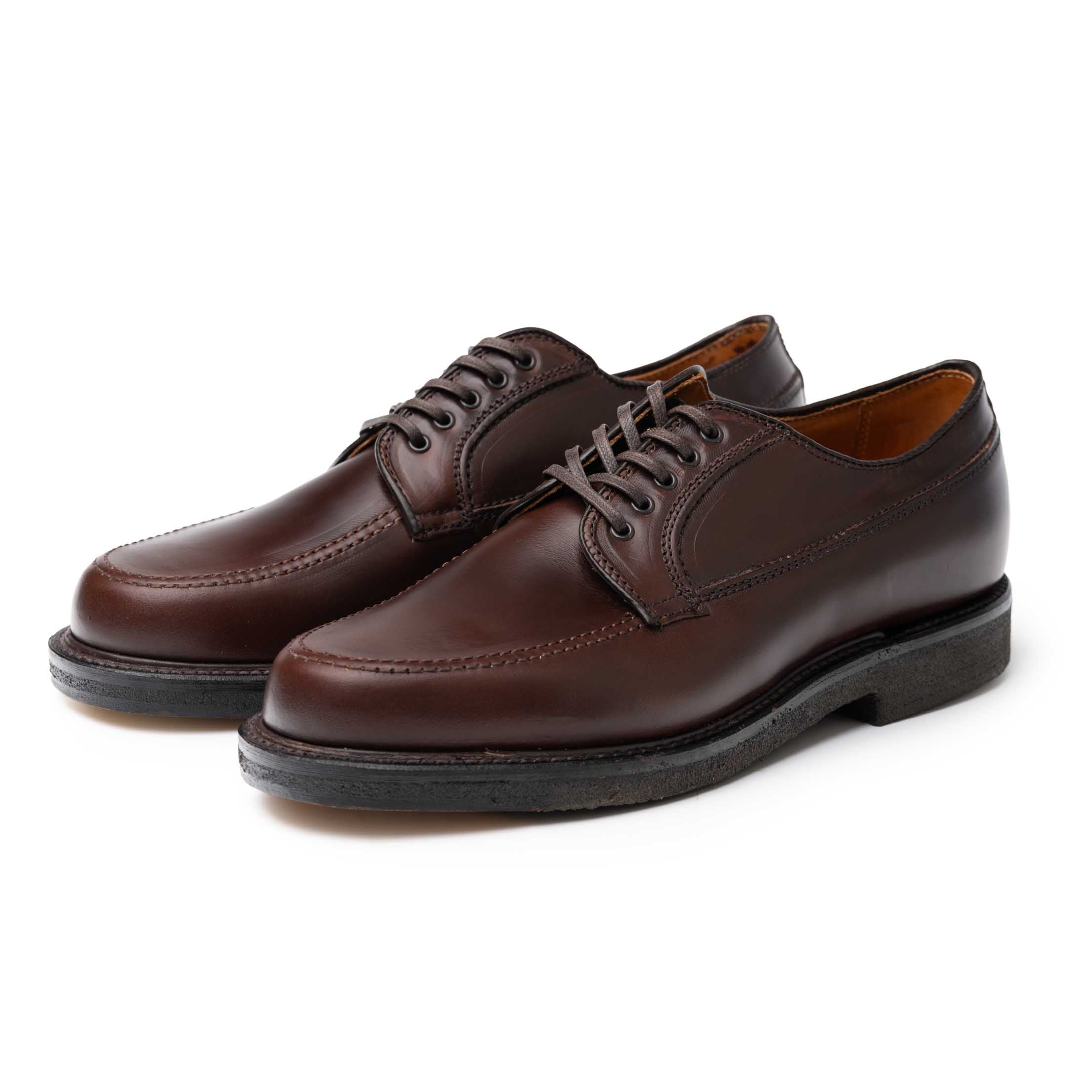A pair of brown Alden x Clutch Cafe M3612 Ranger Moc shoes viewed from the front at an angle.
