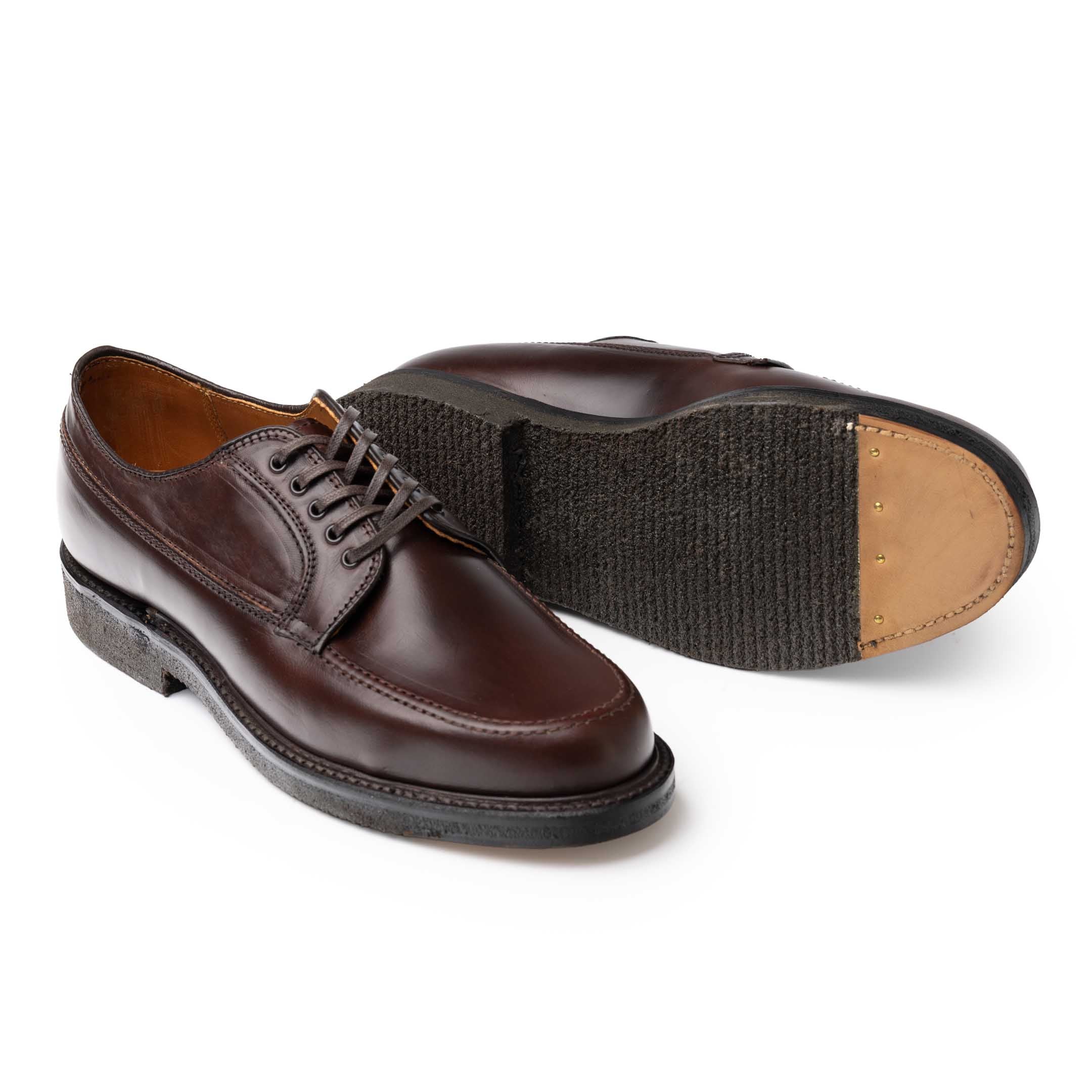 Alden Ranger Moc shoes with one outsole facing up to show the crepe and leather toe section.