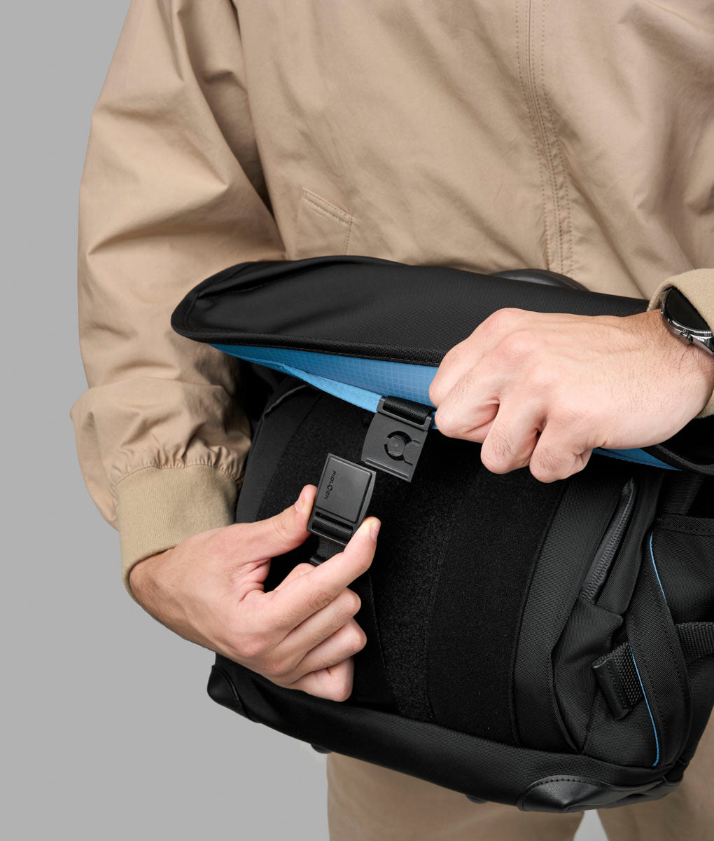 The front flap of the 7ven Messenger being opened to reveal its blue lining.