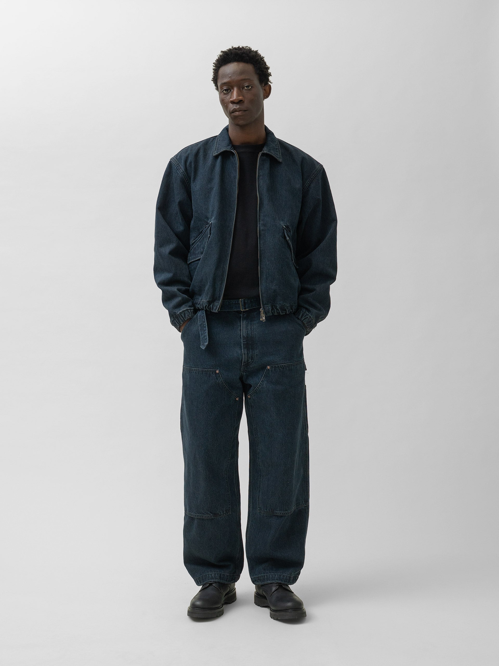 Full-length official styling photograph of the denim blouson with matching trousers.