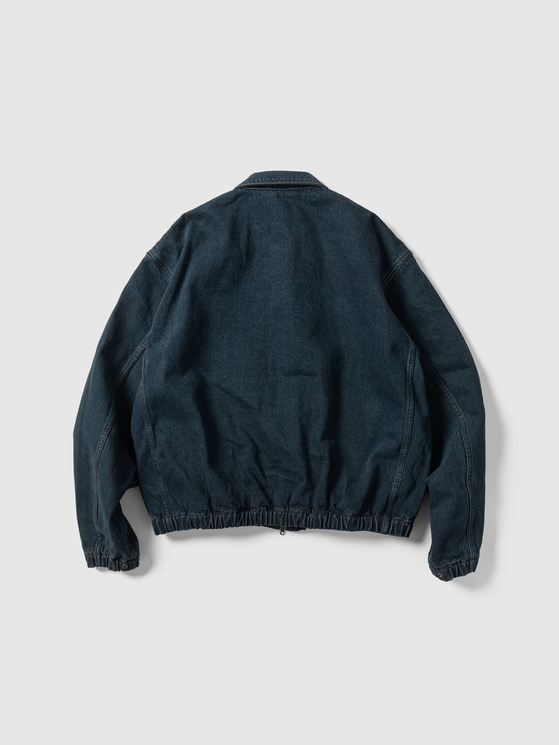 The back of the dark indigo work blouson laid flat.