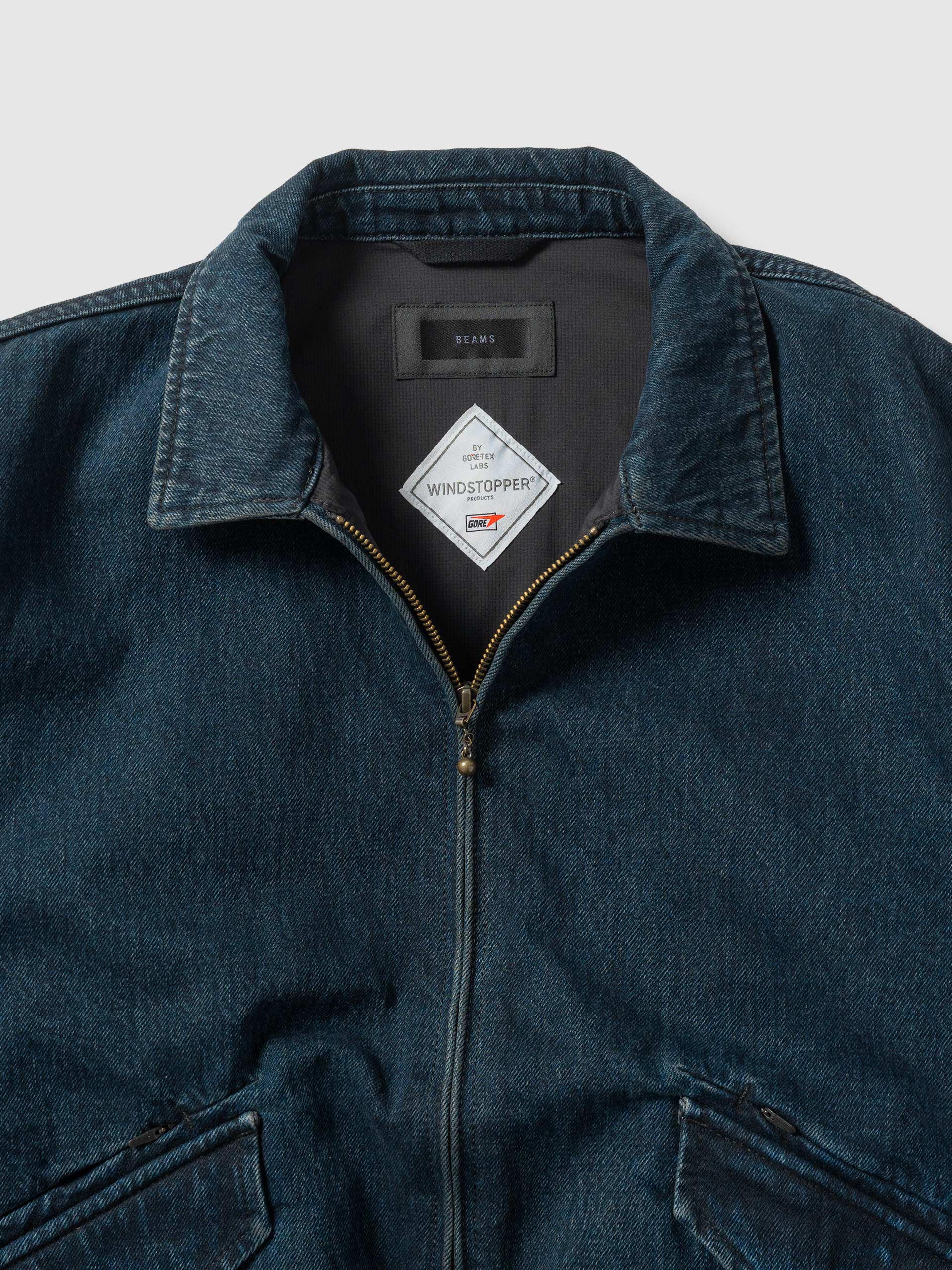 Close view of the jacket collar, label and front zip.