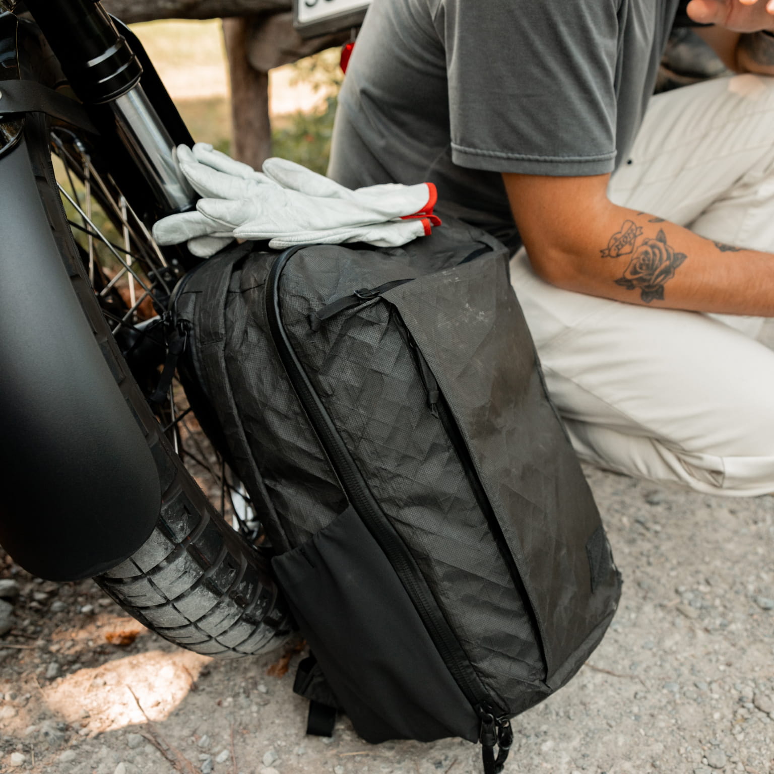 The EVERGOODS CTB26 ULTRA beside a seated person outdoors.