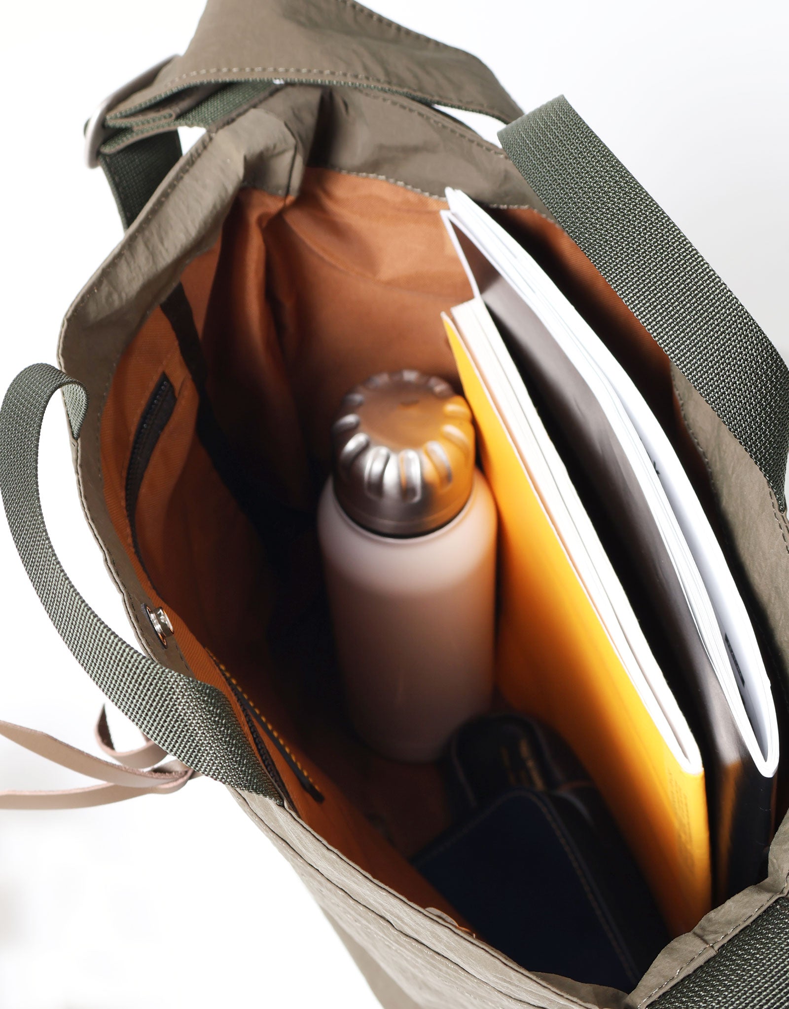 The Khaki Sash M packed with a bottle, documents and small personal items.