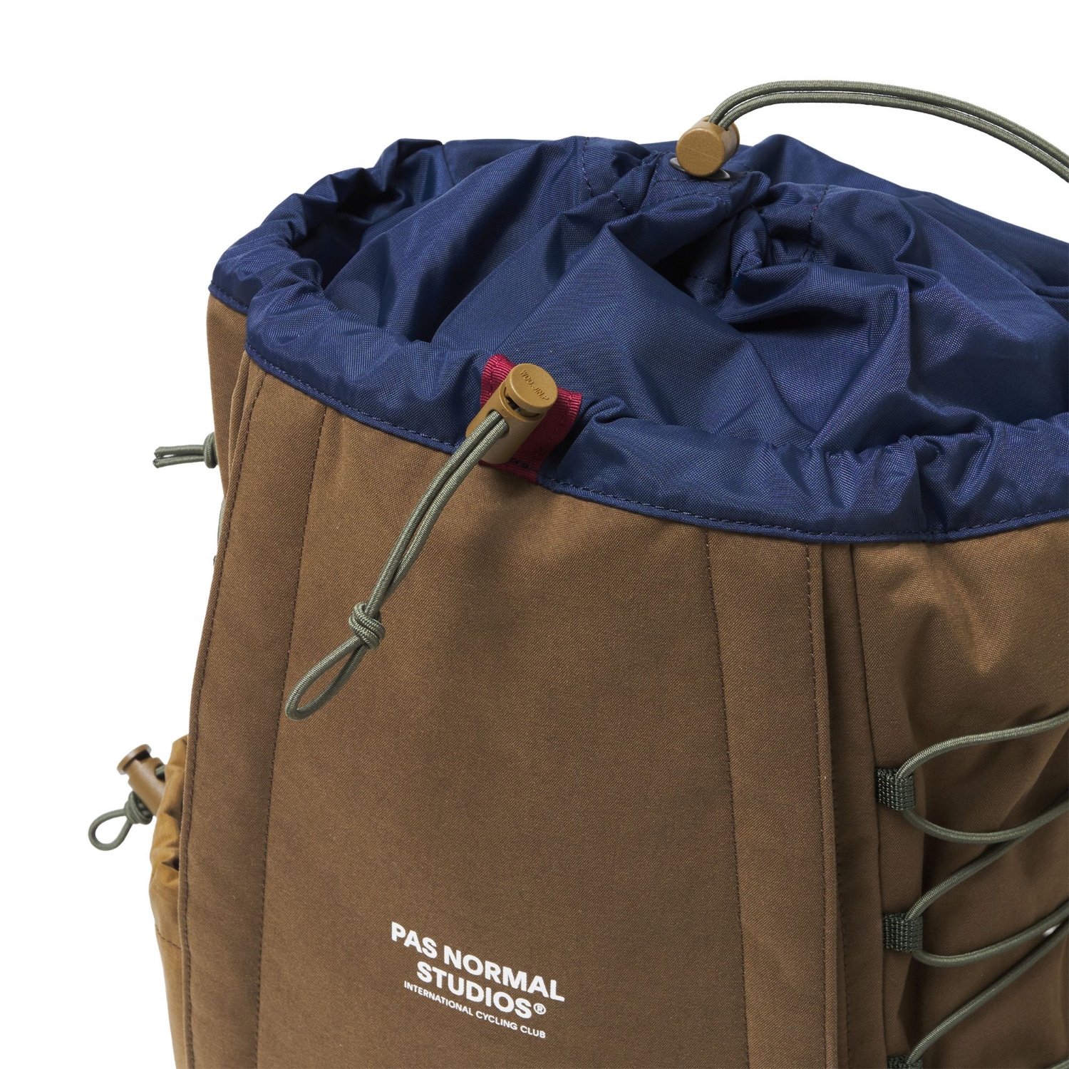 Close-up of the backpack’s navy drawstring opening, with olive cords and brown cord locks.