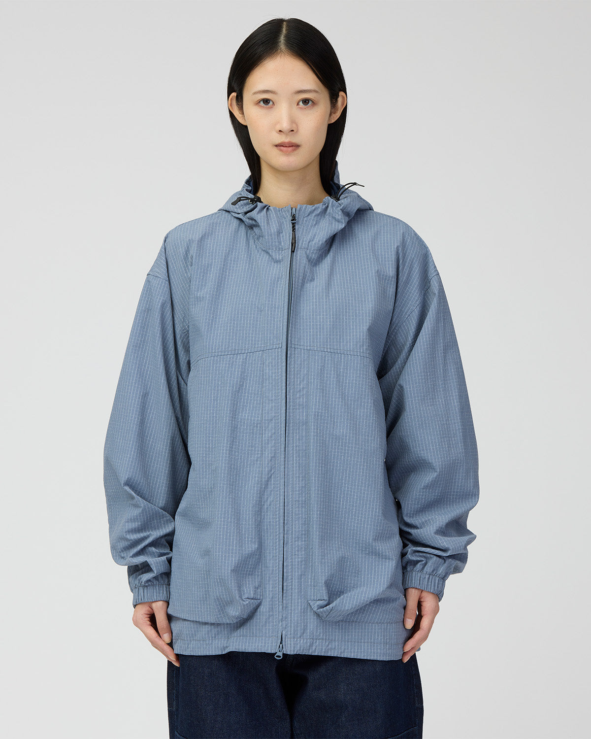Closer front view of the Light Blue jacket, showing the hood and layered pockets.