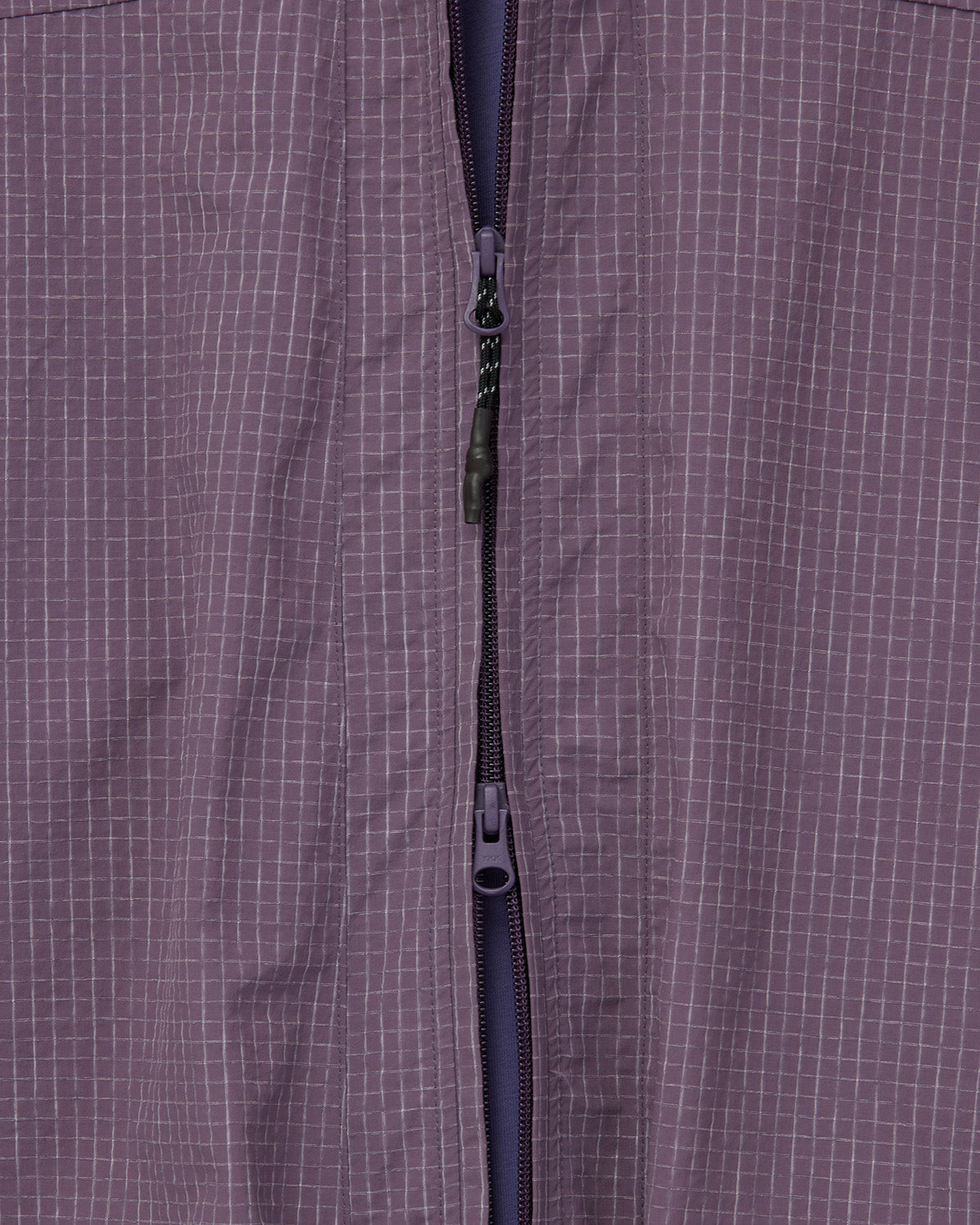 Close view of the Dark Purple fabric's pale ripstop grid and front zip.